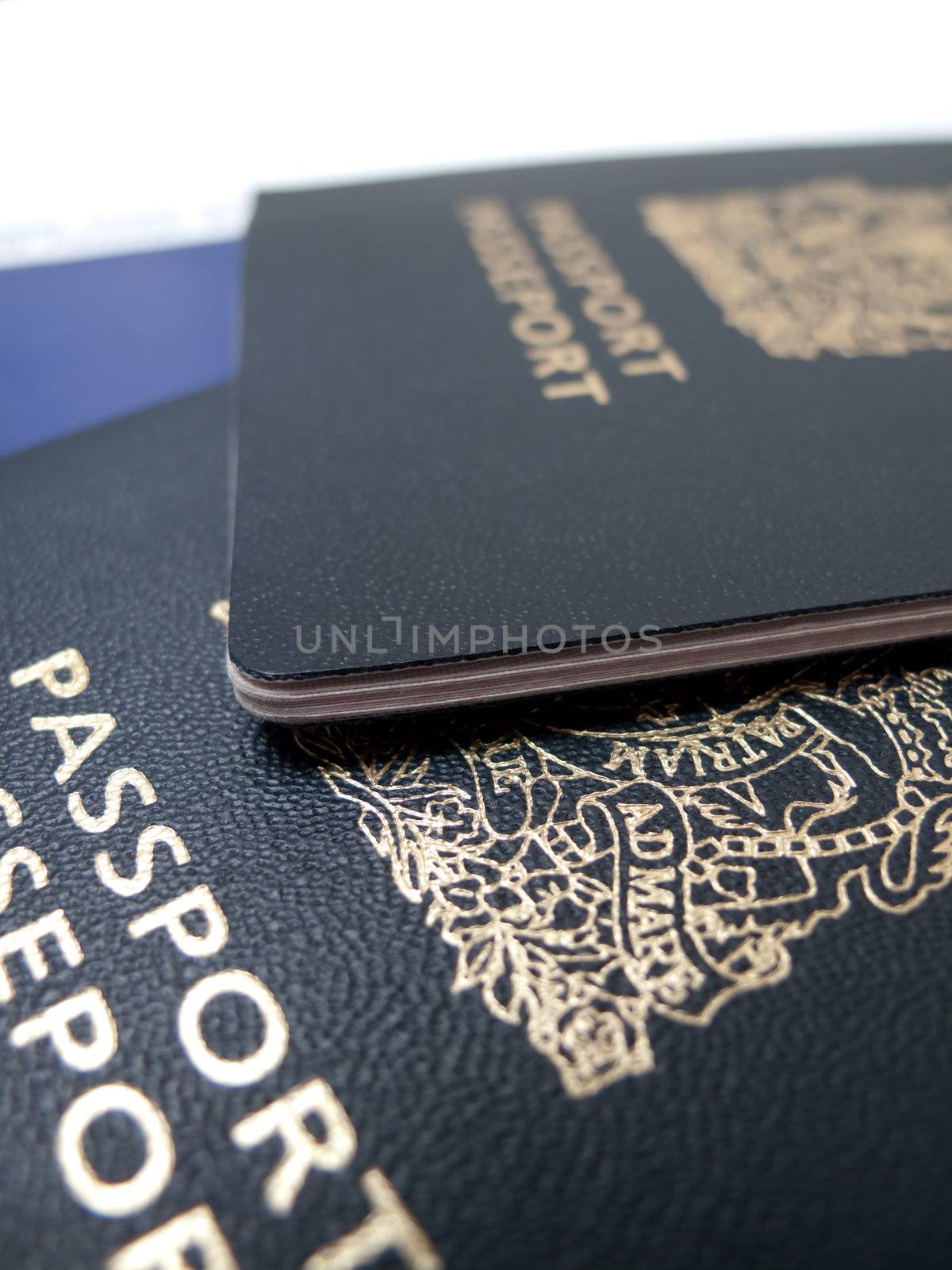 A closeup of two passports, isolated on white.