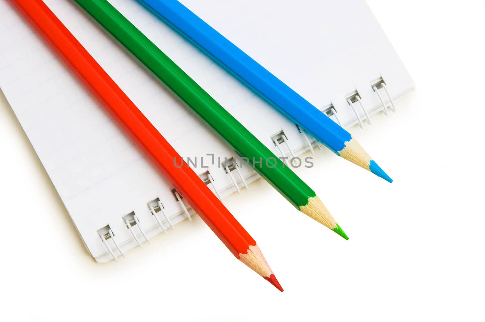 Pencils and notepad isolated on white background