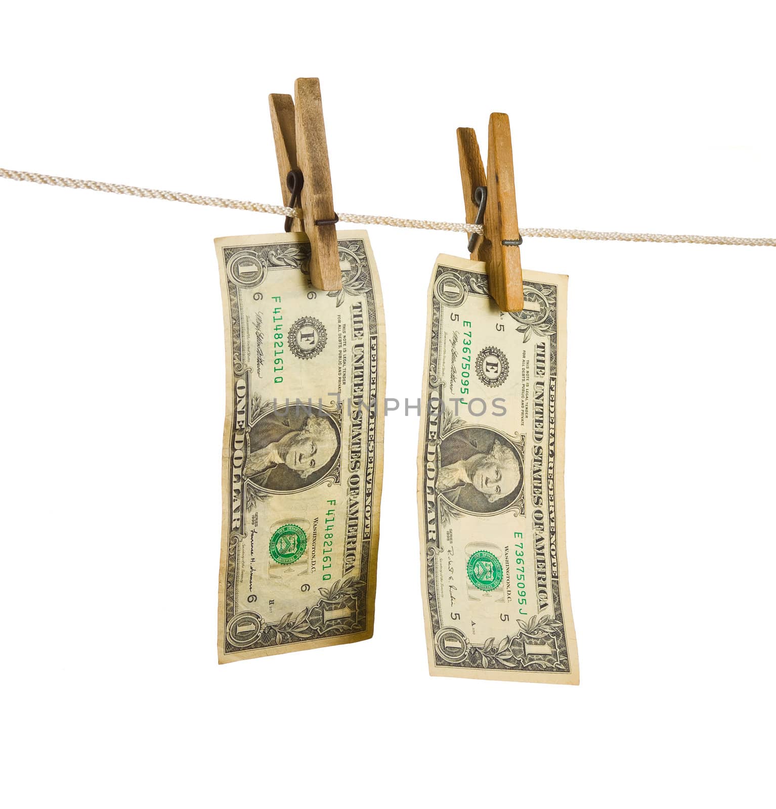 Dollars on clothespin isolated on white background