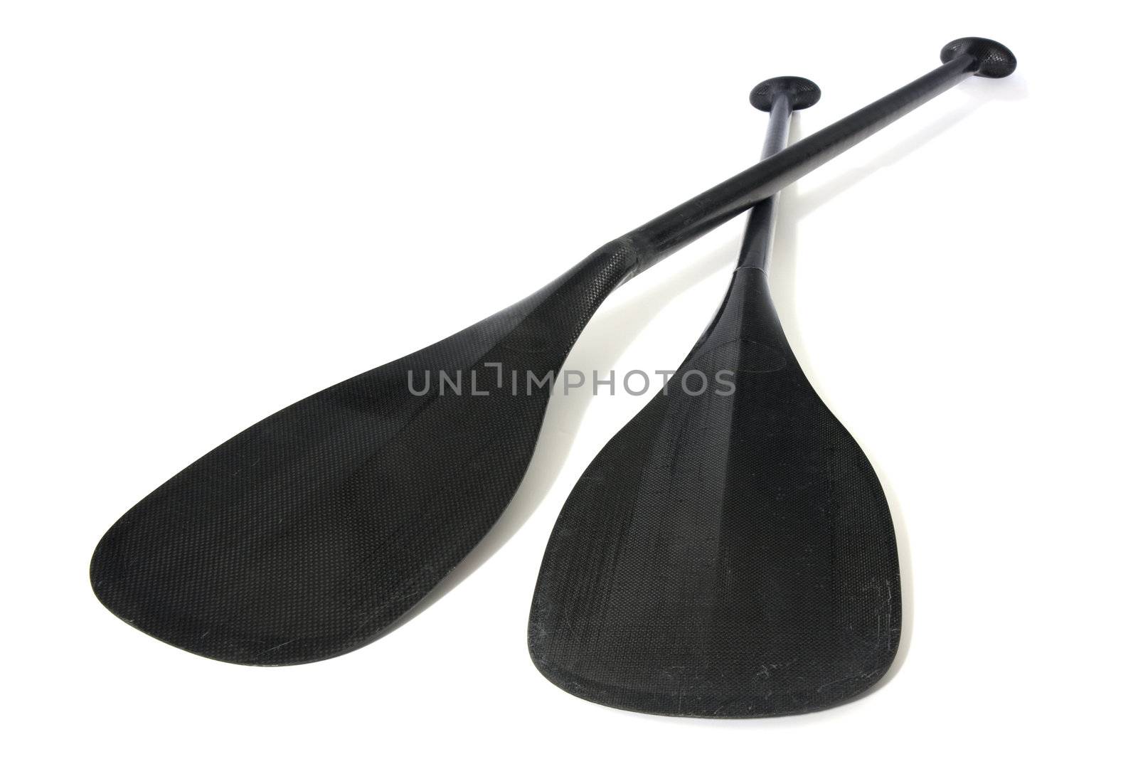 two lightweight carbon fiber paddles for canoe racing, low level angle with focus on blades scratched in river use