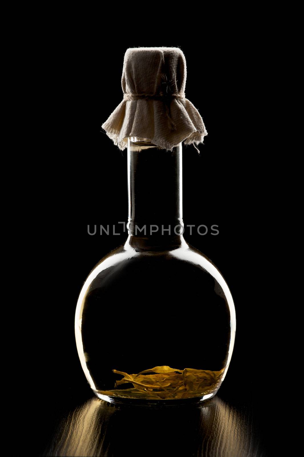 Bottle of vegetable oil in a dark tone