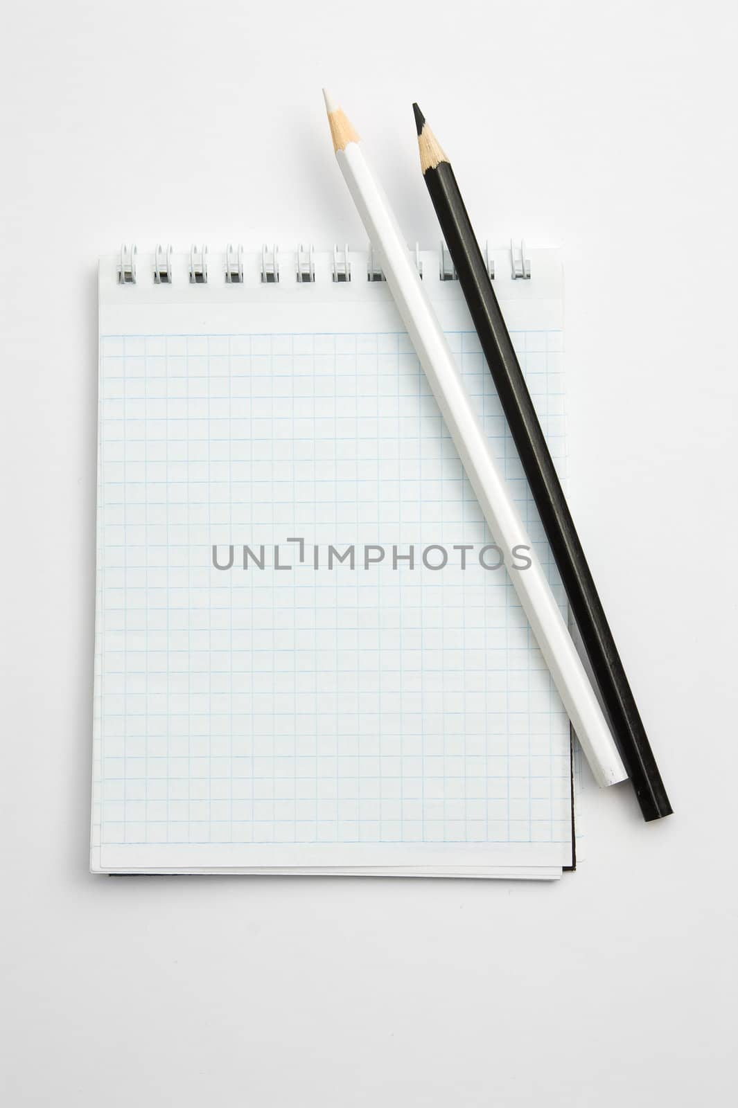 Pencils and notepad isolated on white background