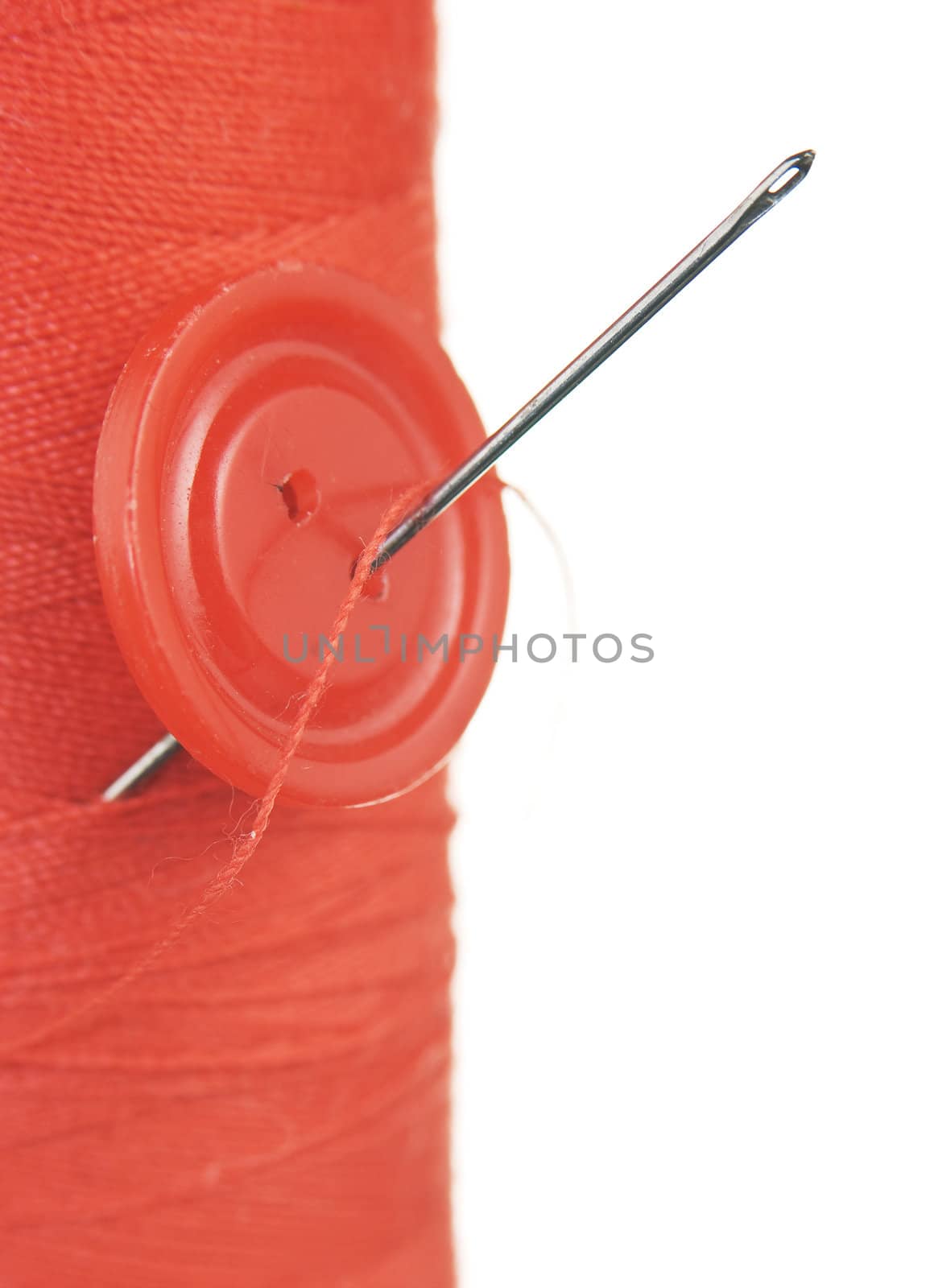 Button with a needle on spool of thread by oleg_zhukov