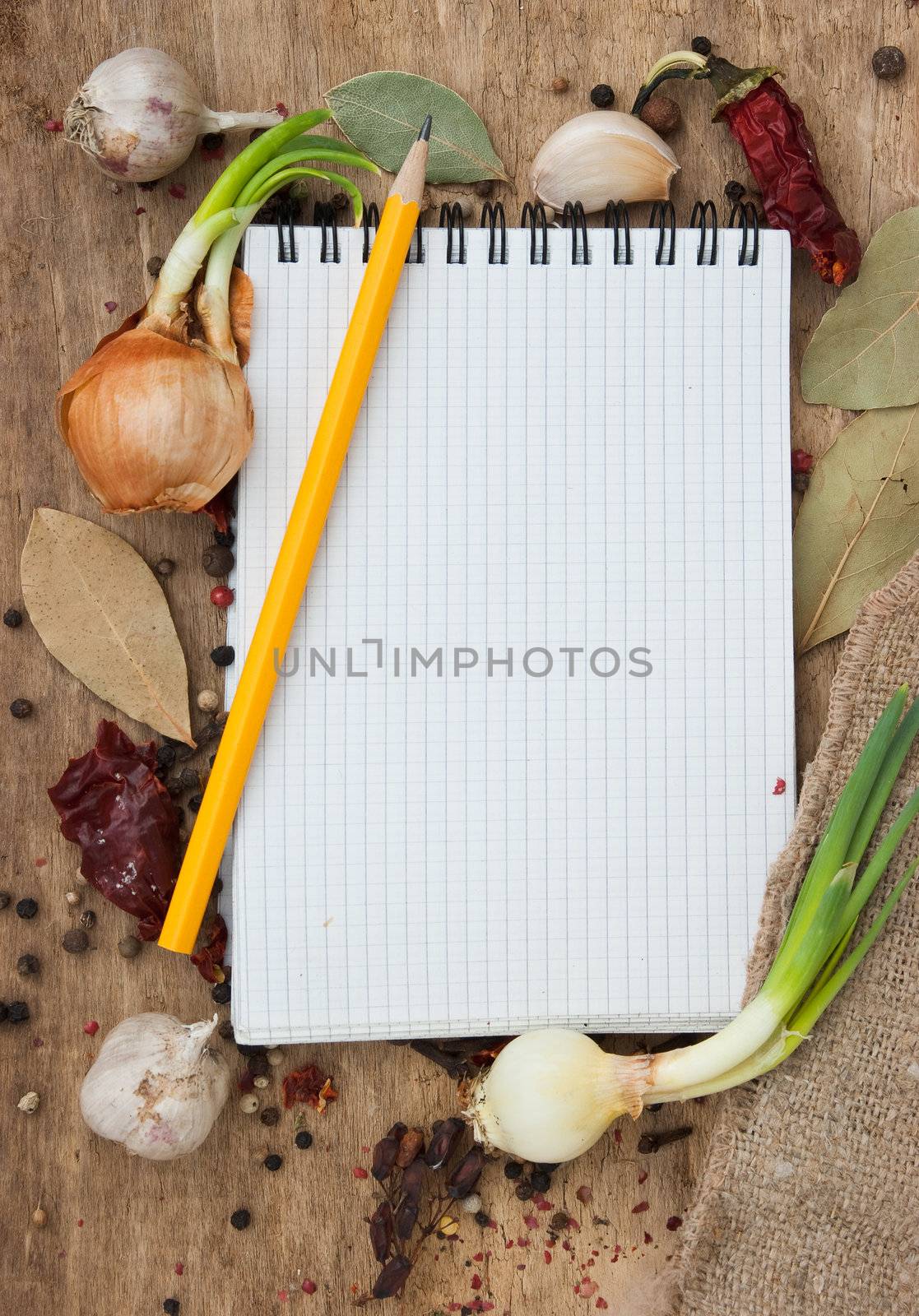 notebook for recipes on the background of spices and table
