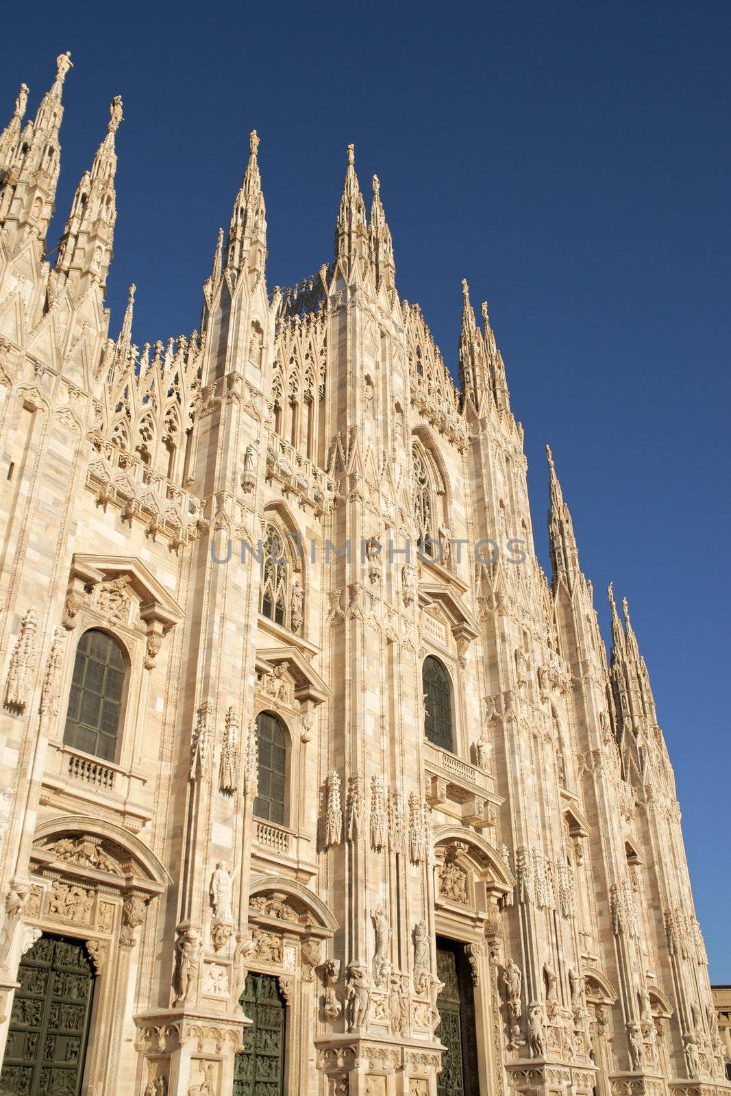 Gothic facade of Milan Cathedral in Piazza del Duomo. It is the fourth largest church in the world. The construction started in 1386 and took about five centuries.