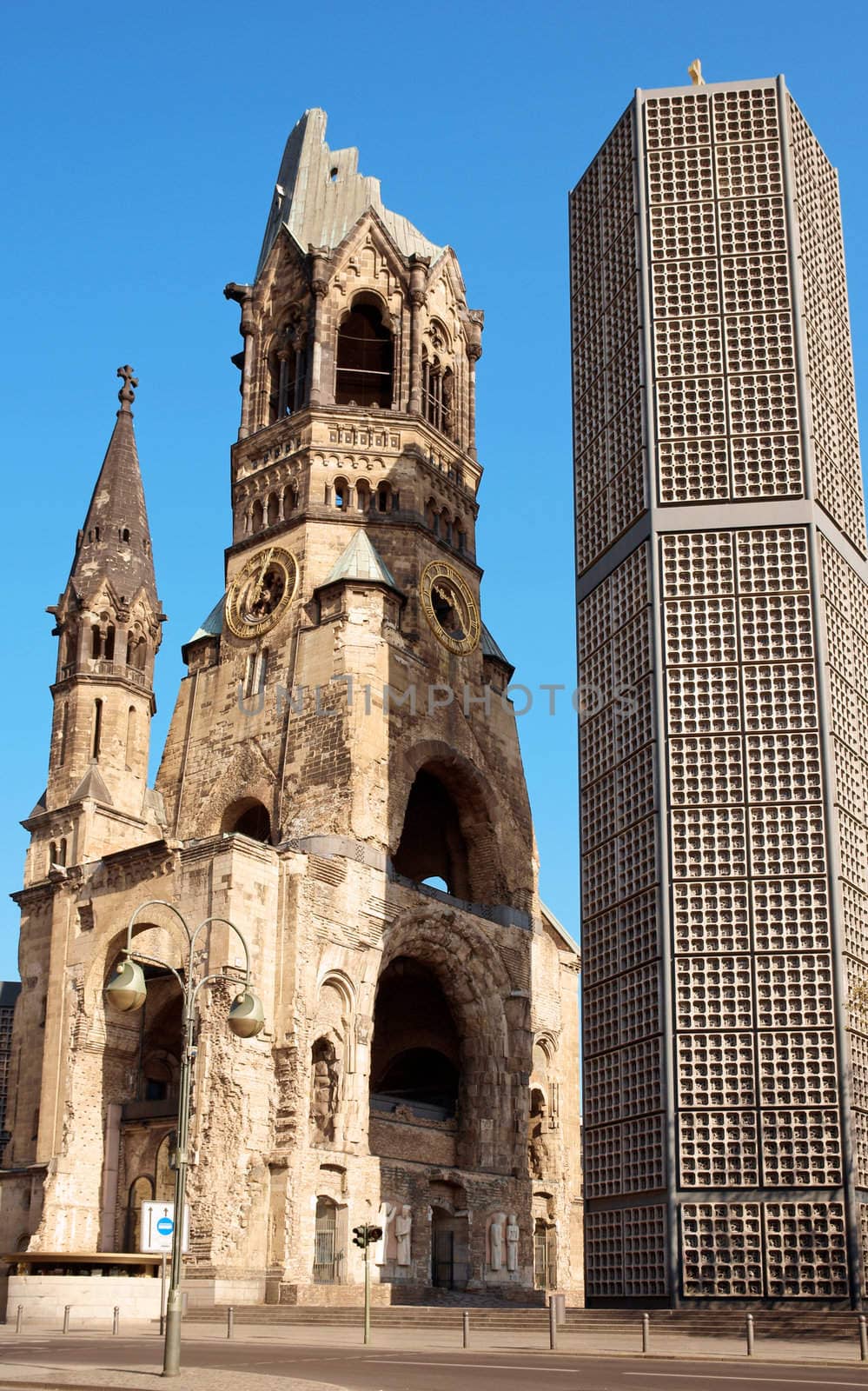 Kaiser Wilhelm Memorial Church in Berlin. Historical church hit and damaged by allied air forces during the second world war and never restored. On the right the bell tower of the modern new church.