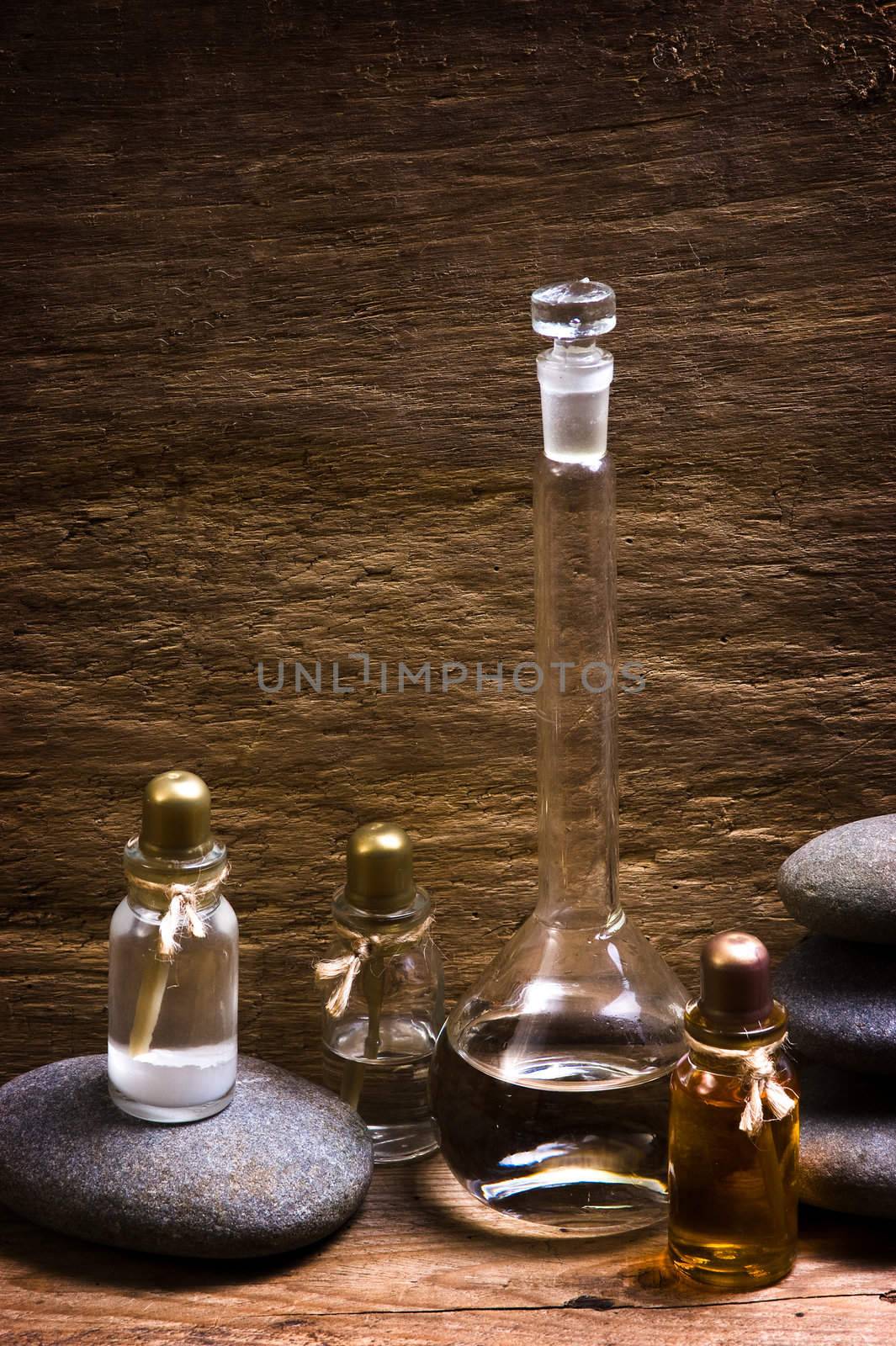 Vials with essential oils against the old wooden walls