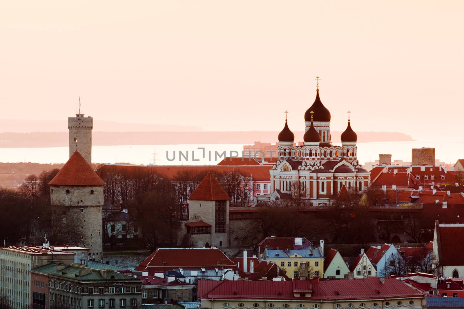 Capital of Estonia, Tallinn is famous for its World Heritage old town walls and cobbled streets. Sunset illuminates the Alexander Nevsky Cathedral and castle walls