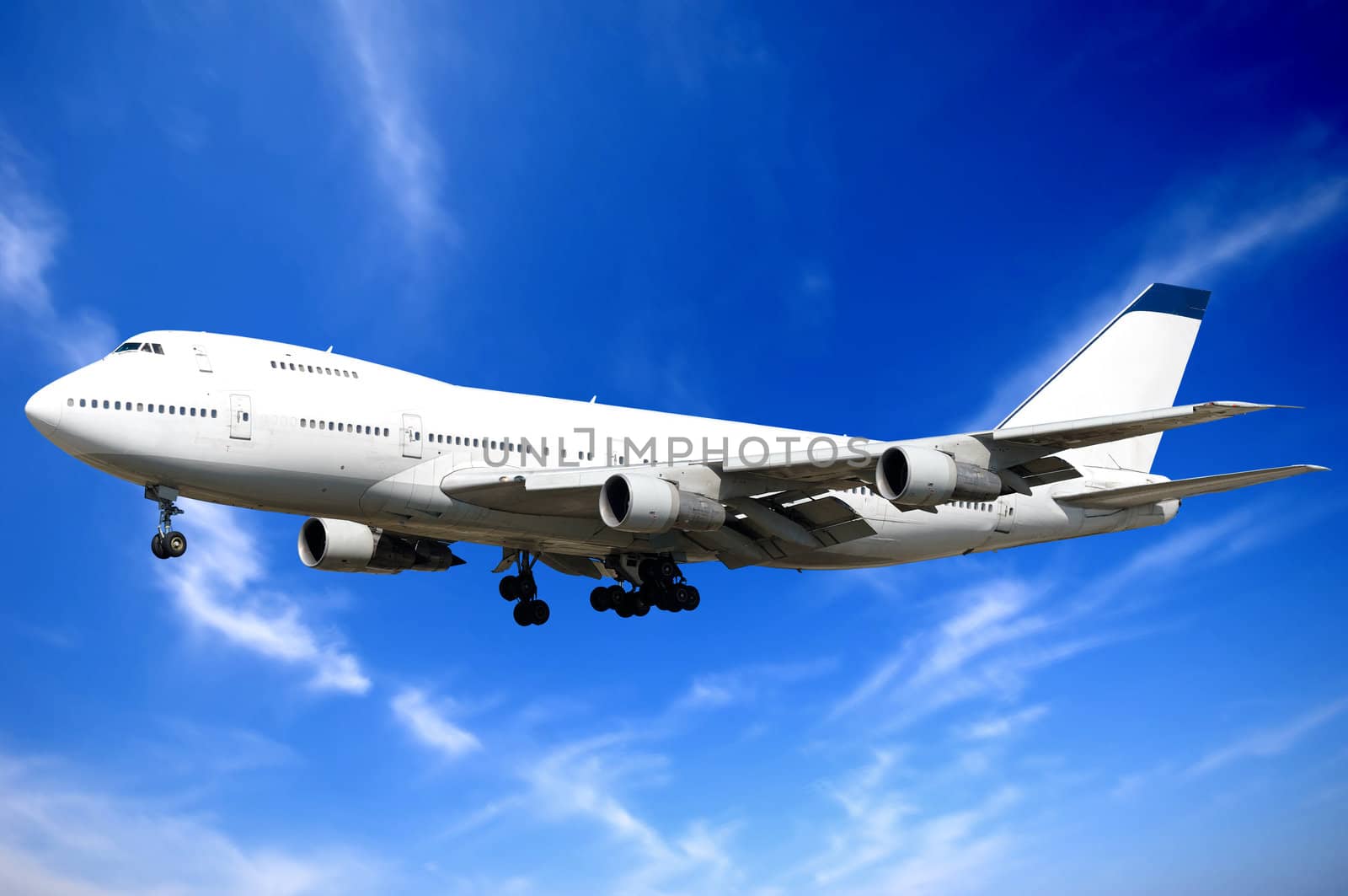 Jumbo jet and blue and cloudy sky.