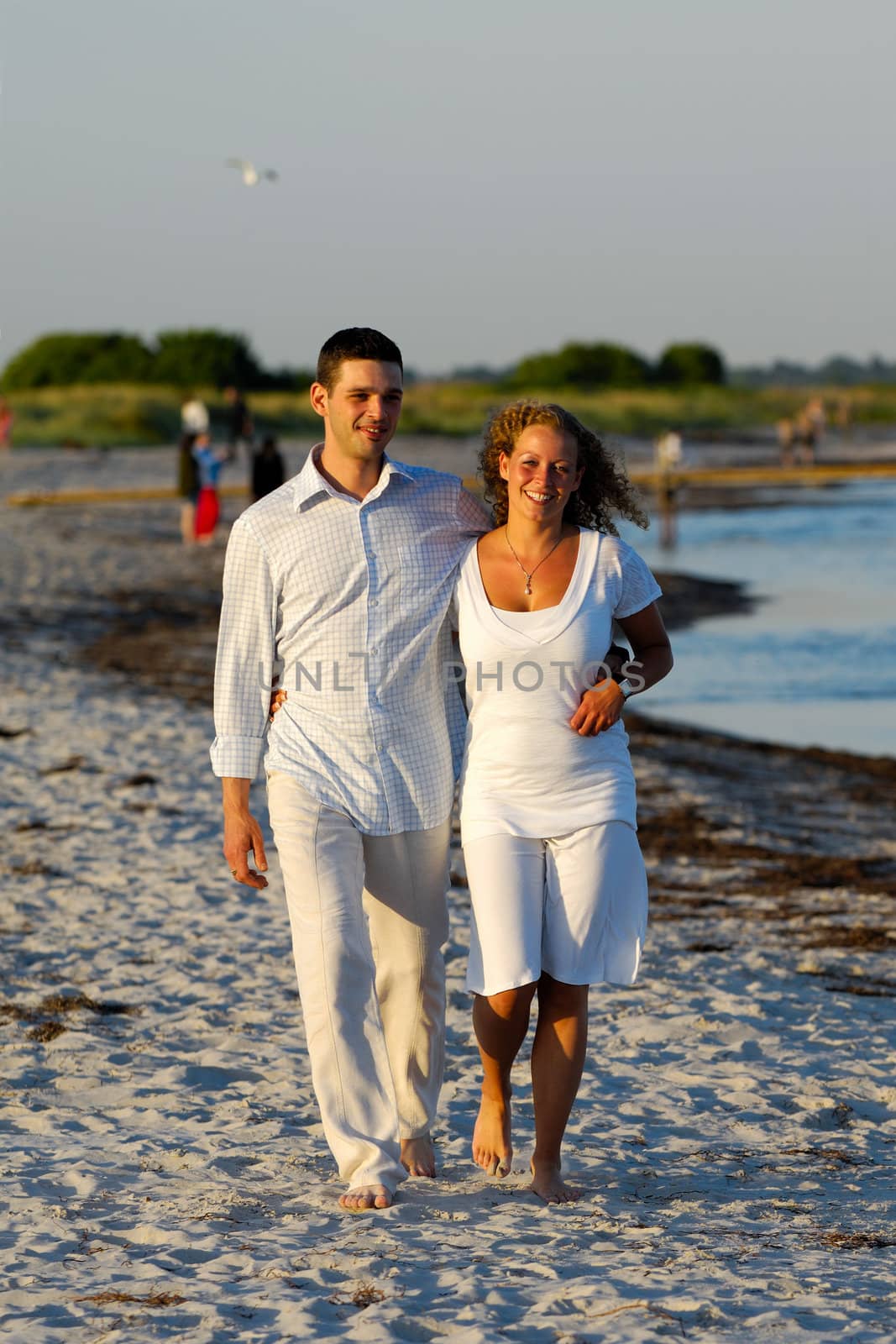 Young couple walking on beach by cfoto