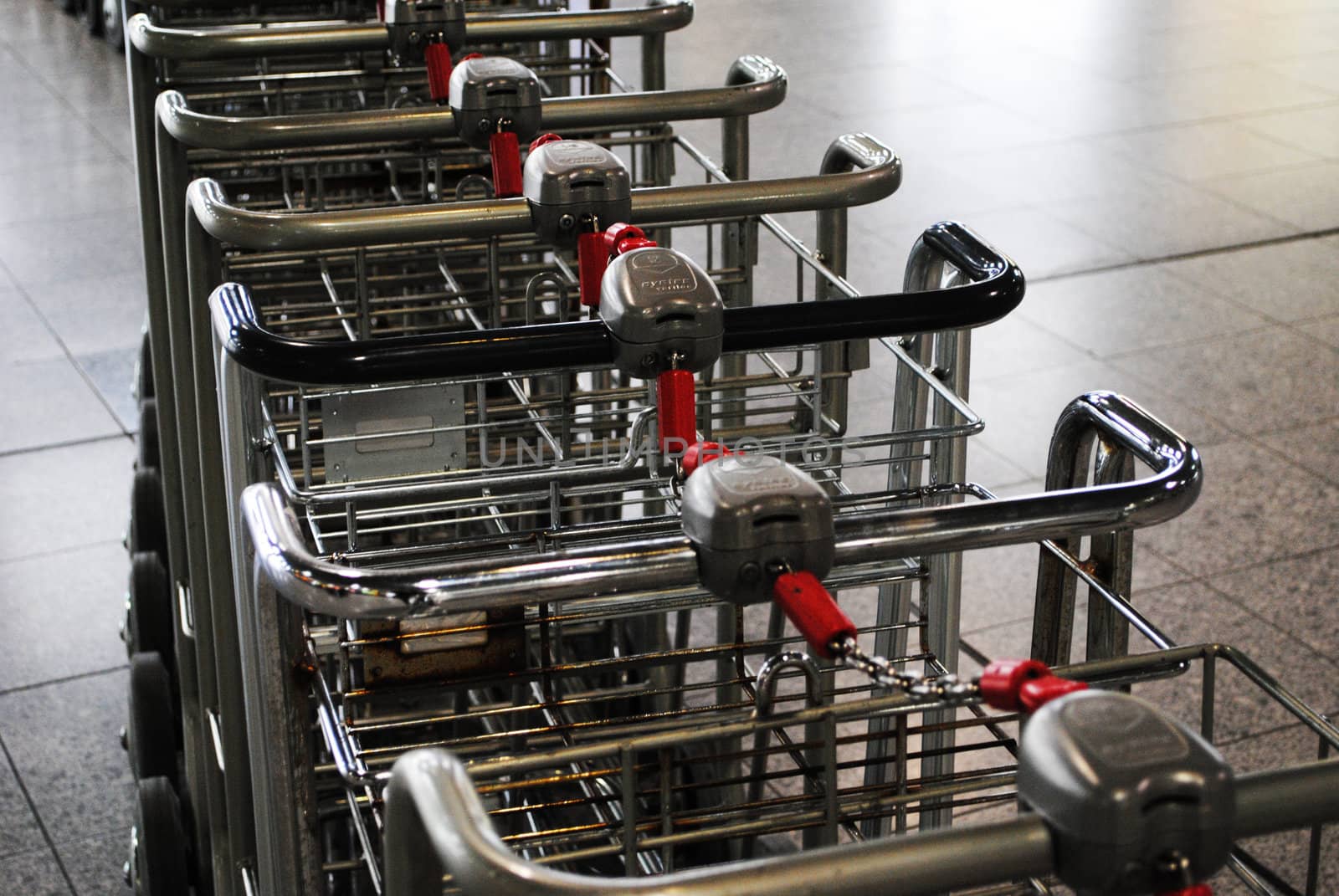 A row of trolleys at an airport.
