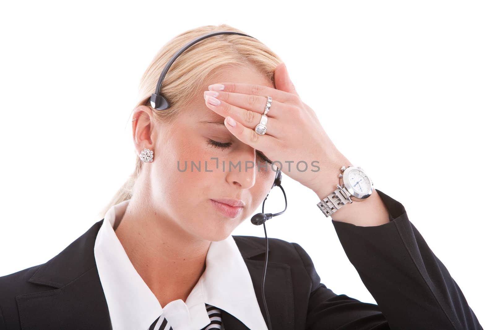 Receptionist with headset having a headache and reaching for her forehead