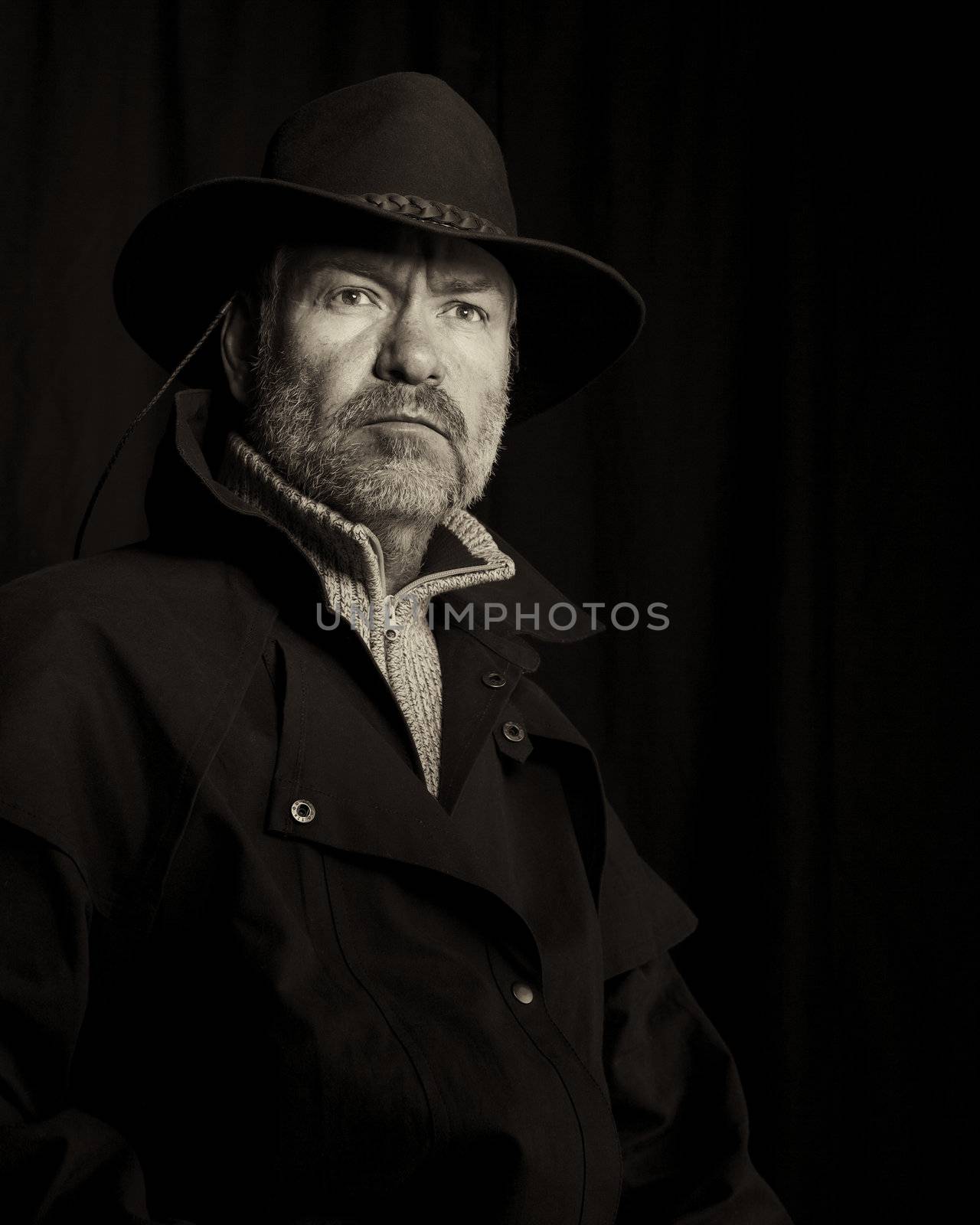 Old style portrait of a rugged looking cowboy