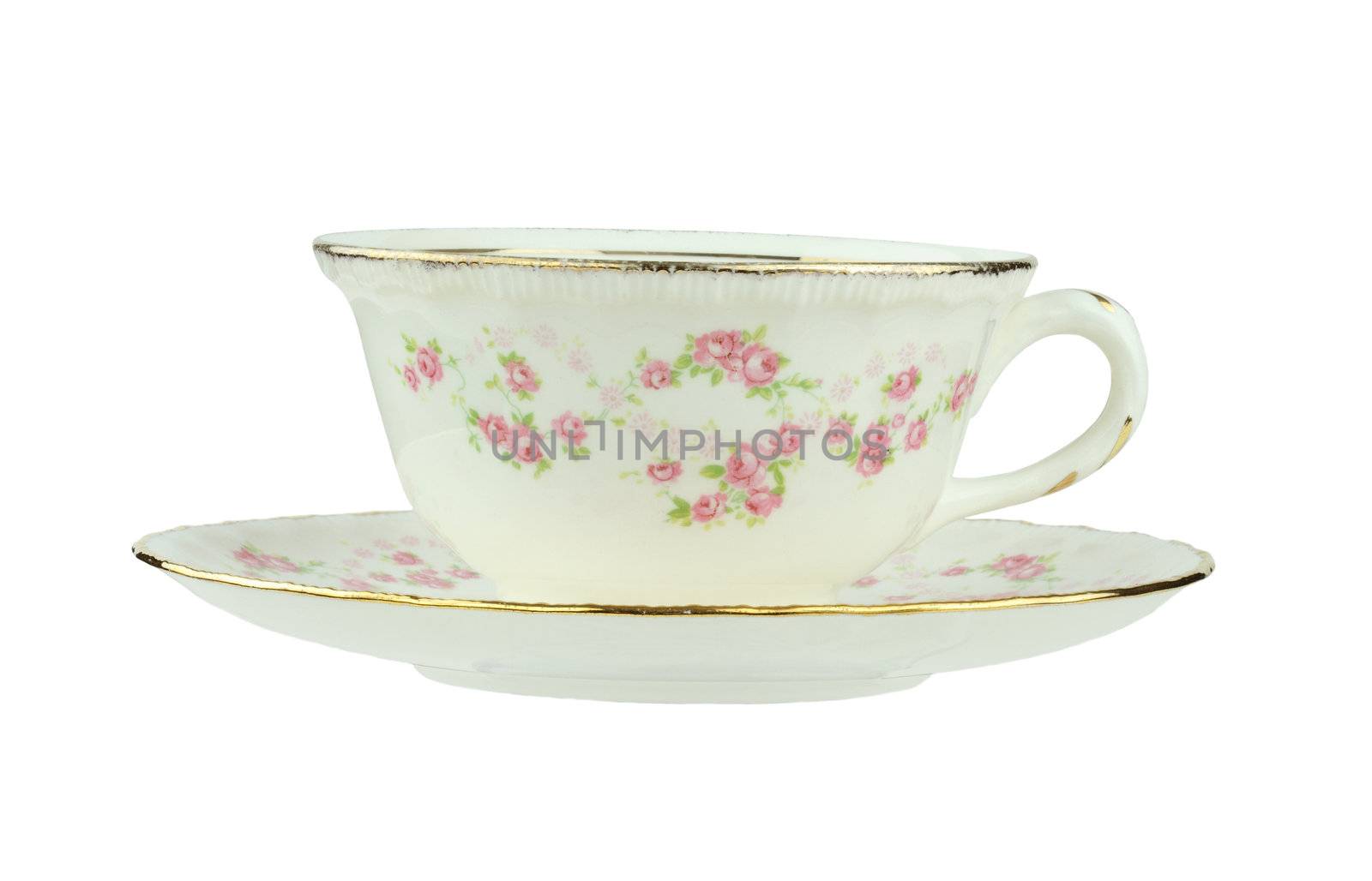 Flowered antique tea cup and saucer isolated on a white background with clipping path.
