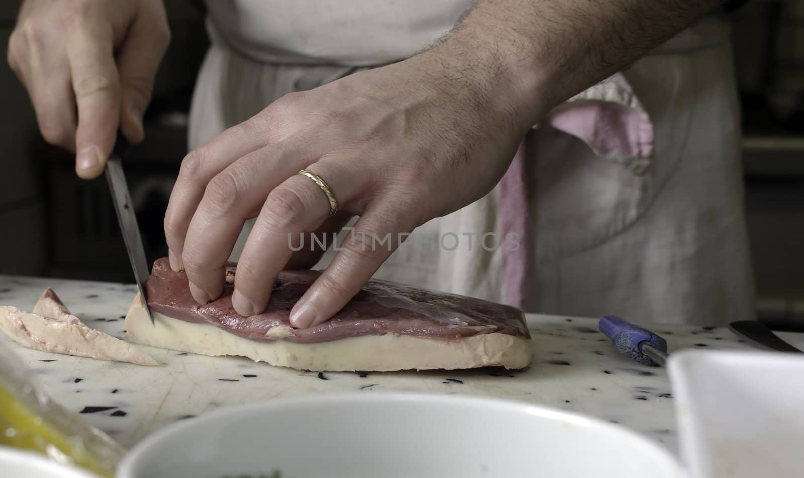 a cook cutting meat