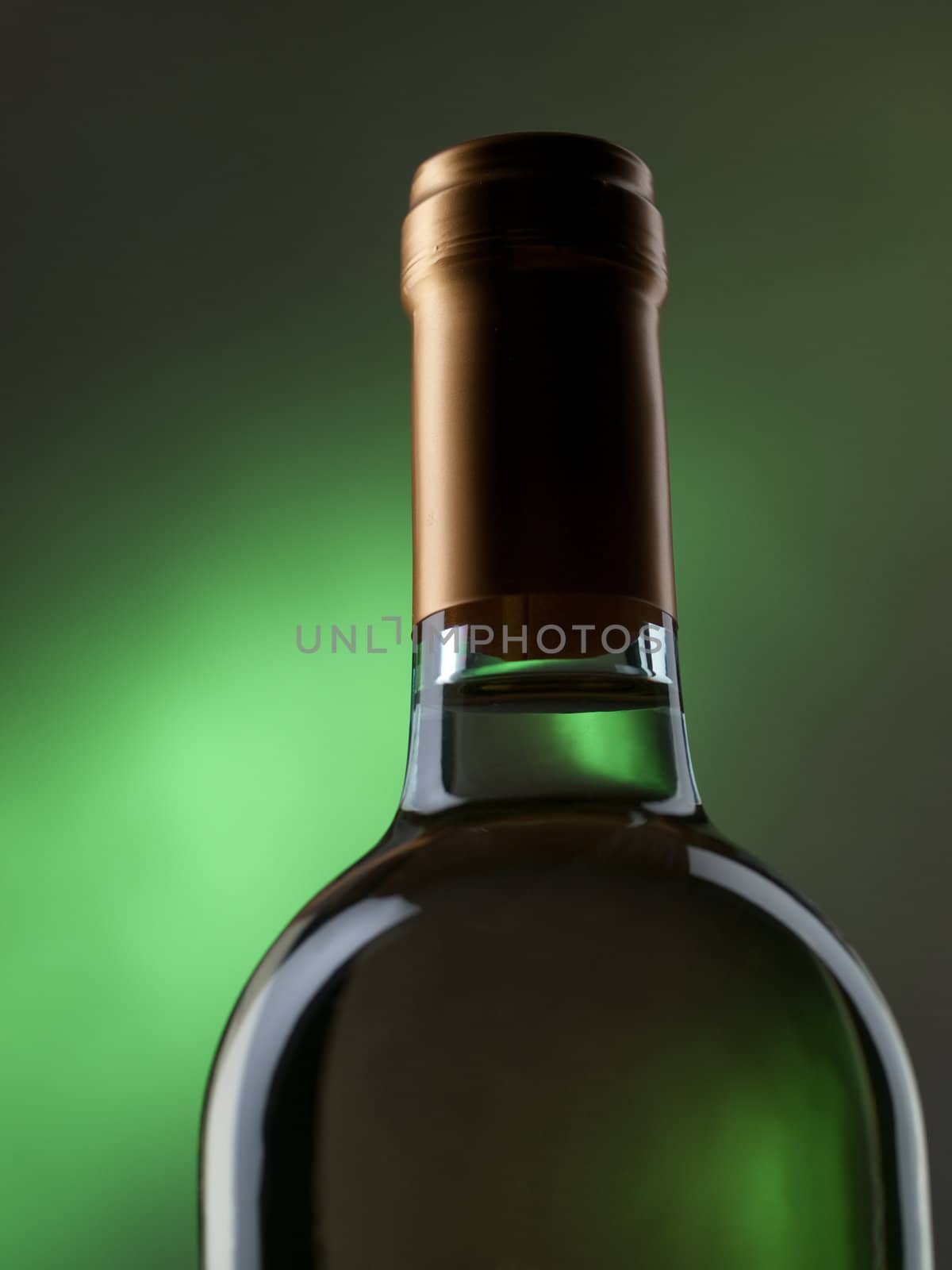 Bottle of white wine on green background