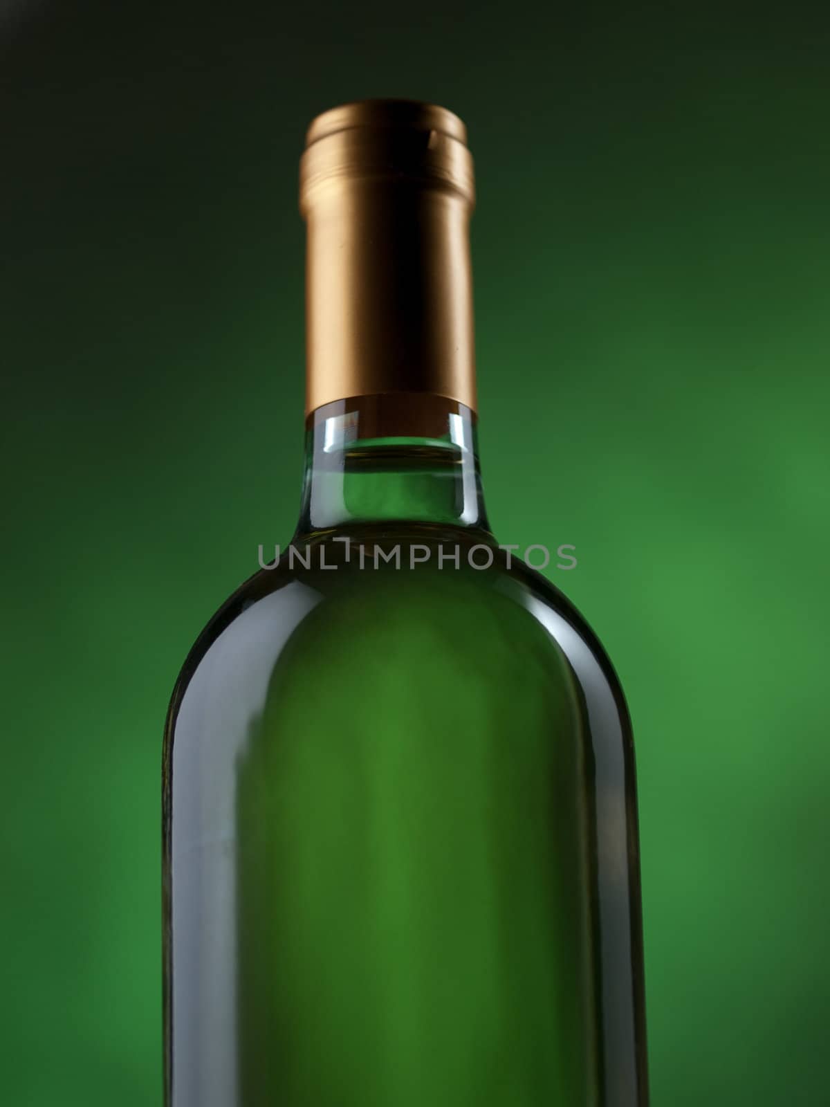 Bottle of white wine on green background