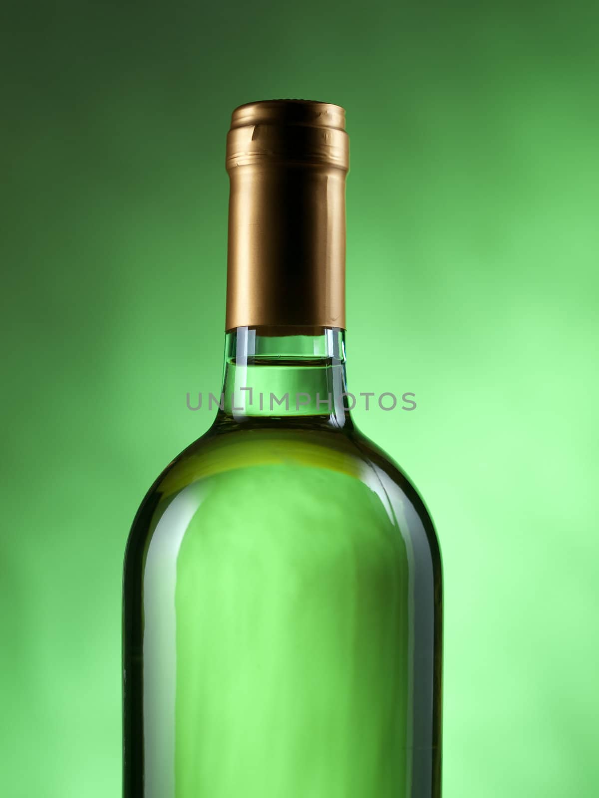 Bottle of white wine on green background