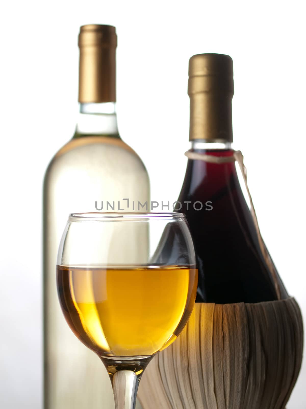 Bottles of white and red wine with wineglass