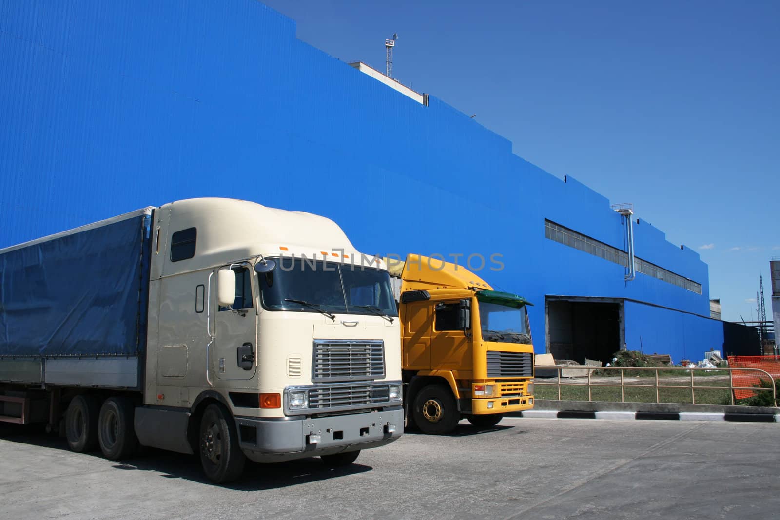 lorries on a background of a dark blue warehouse