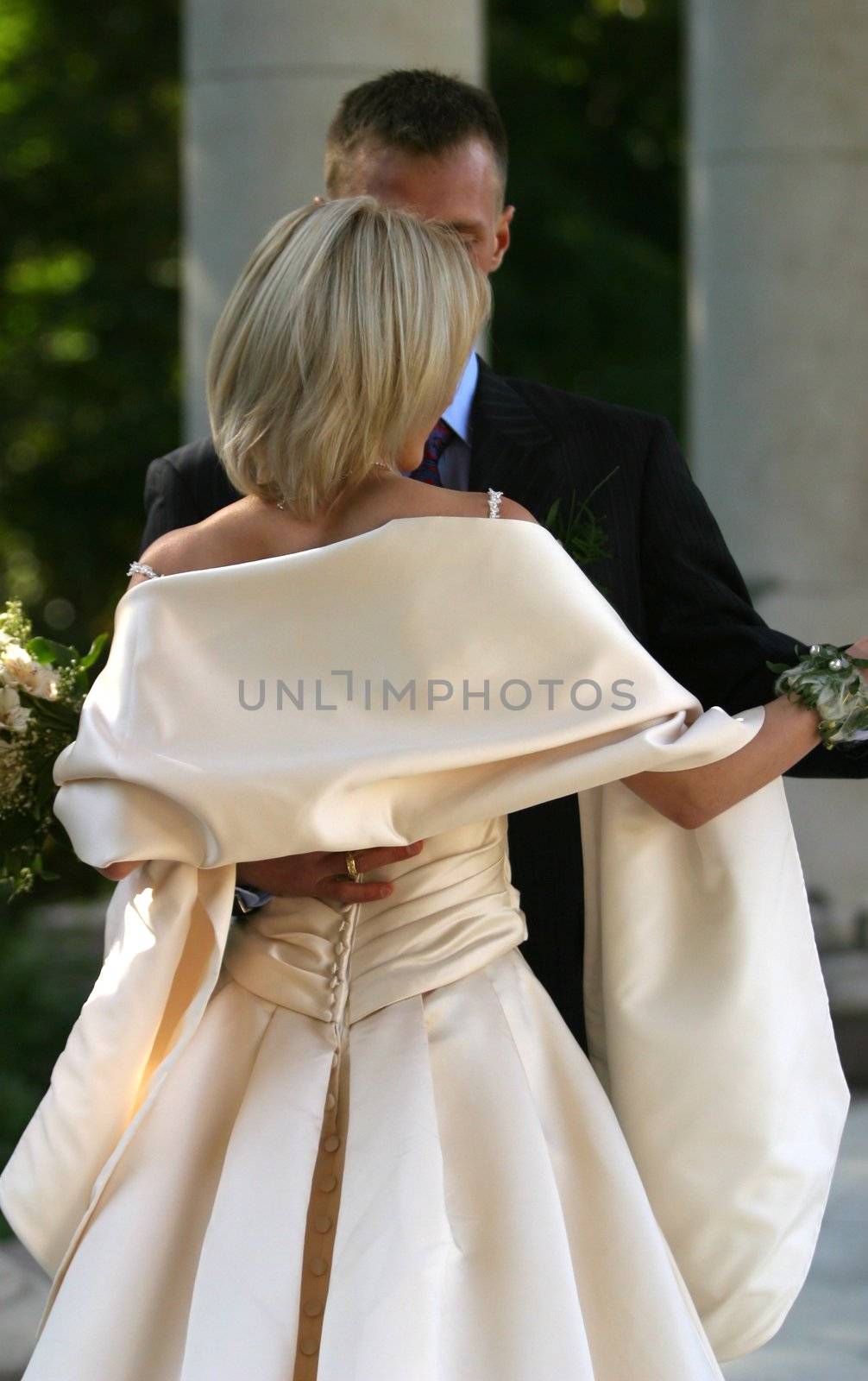Recently married pair in embraces each other