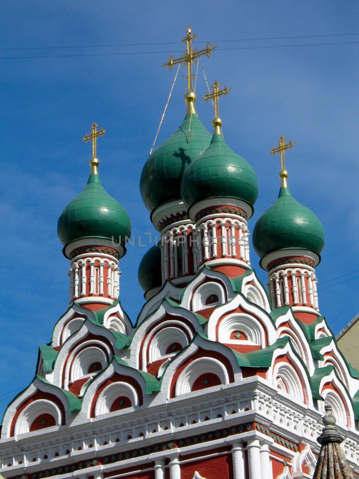 Cupolas and Crosses of Russian Orthodox Church with blue sky as background. Trinity church in Nikitniky, Moscow