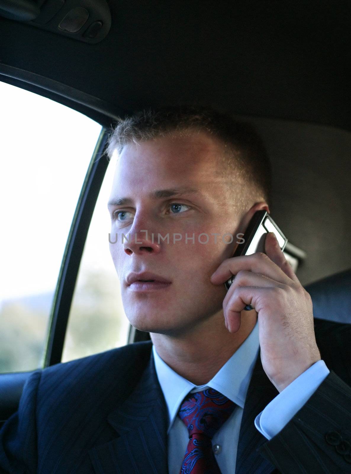 The puzzled young man speaks by the phone