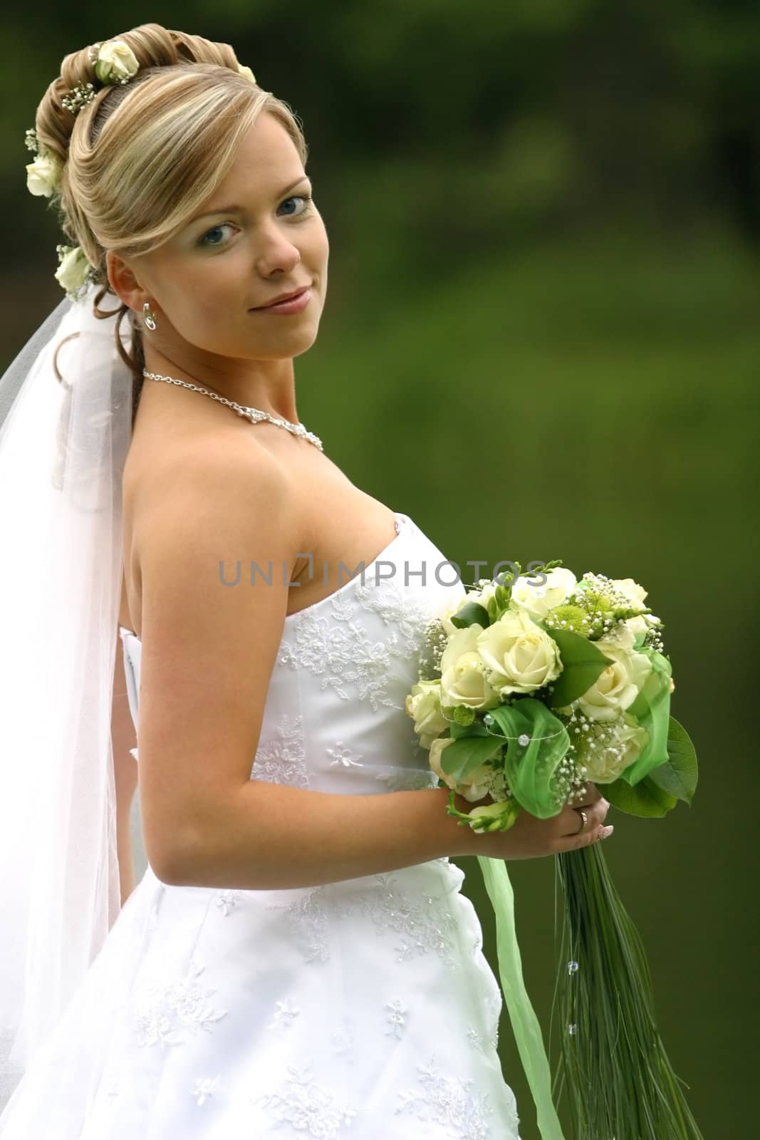 Portrait of the beautiful bride with a bouquet