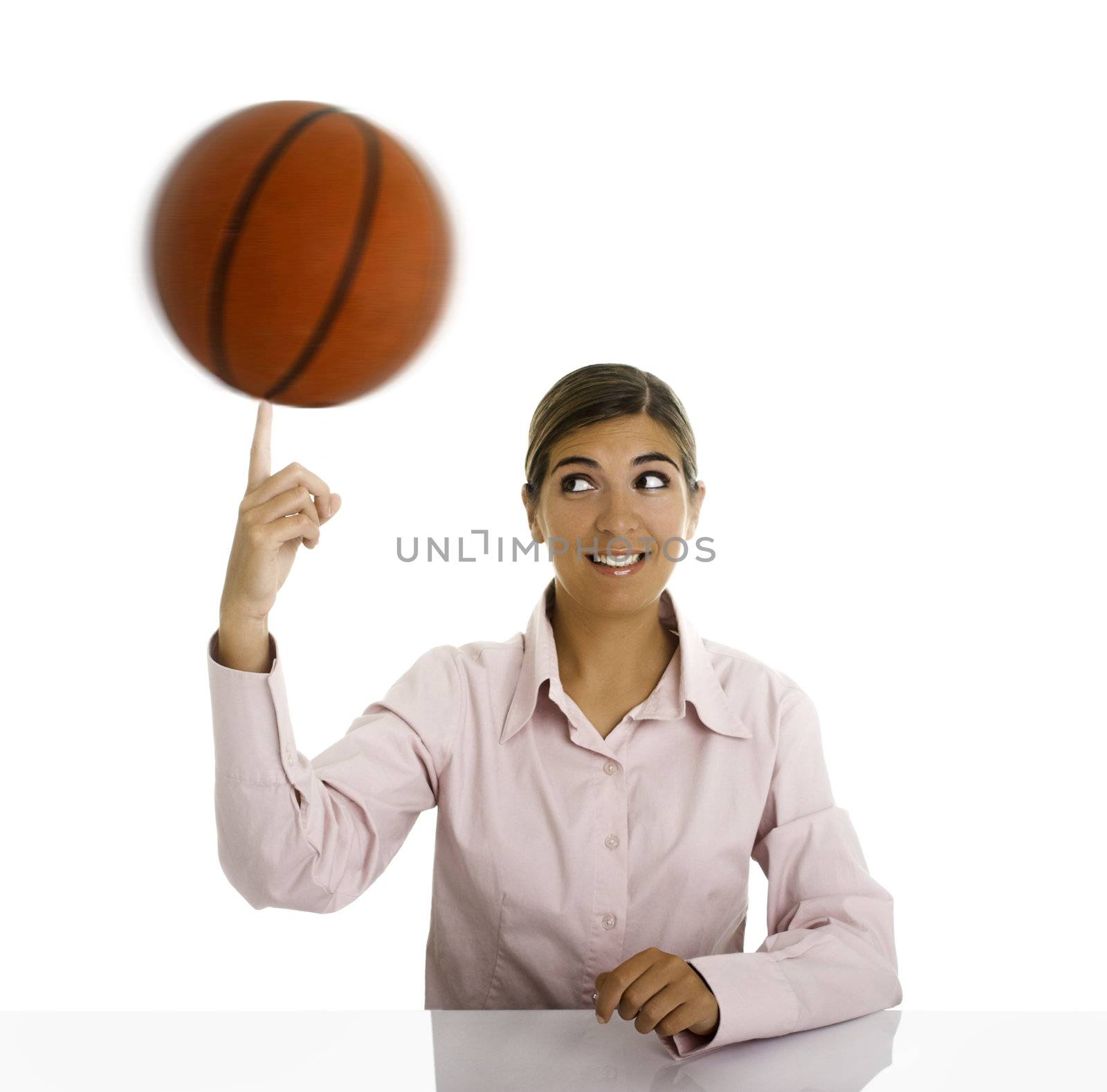 Woman with a basketball rolling on is hand