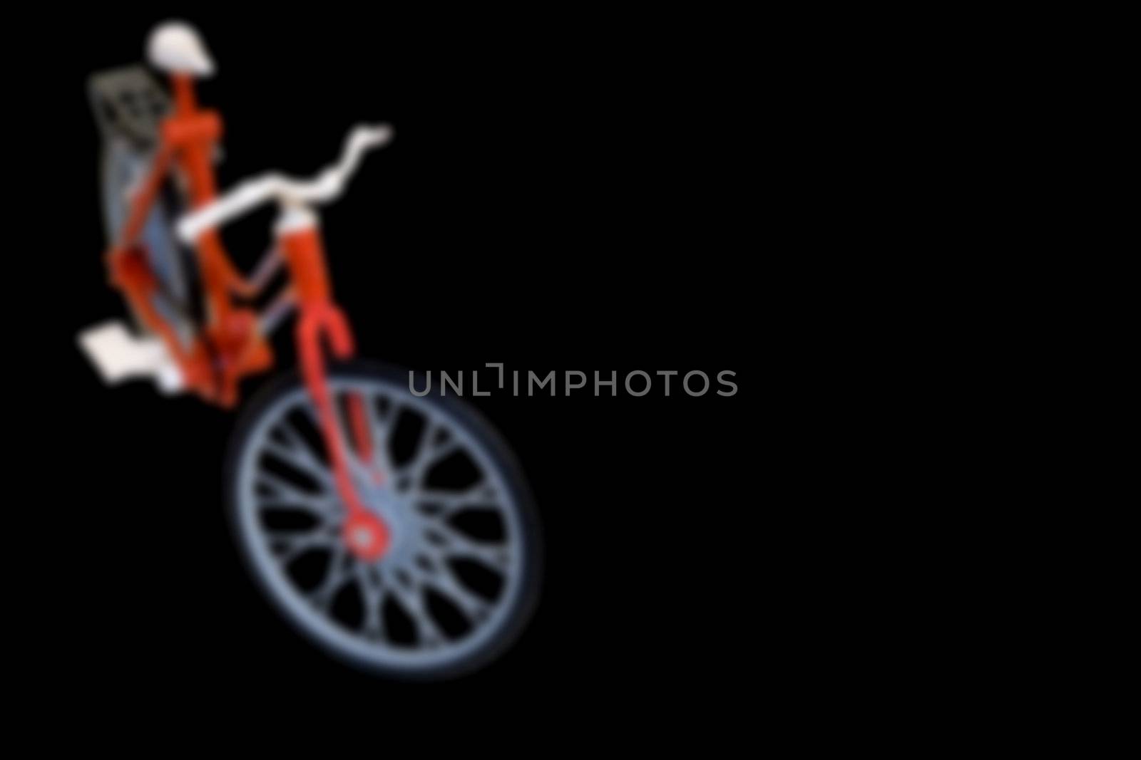 Blurred Bycicle on Black Background with plenty of copy space.