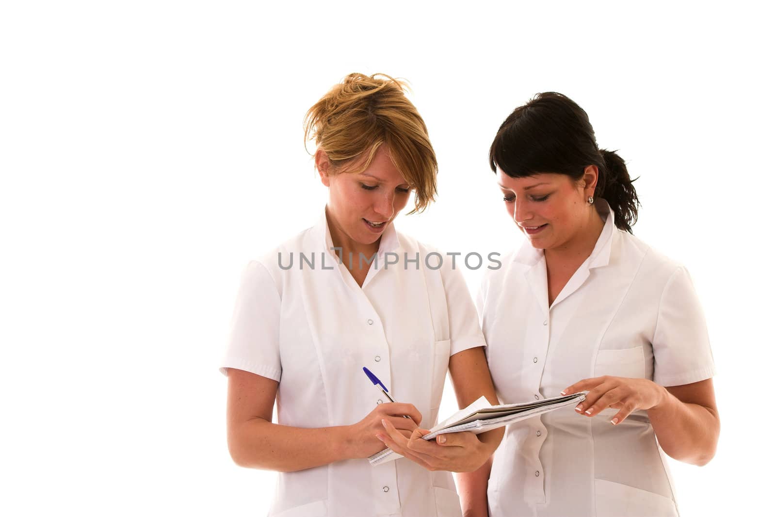Two nurses discussing their notes on white background