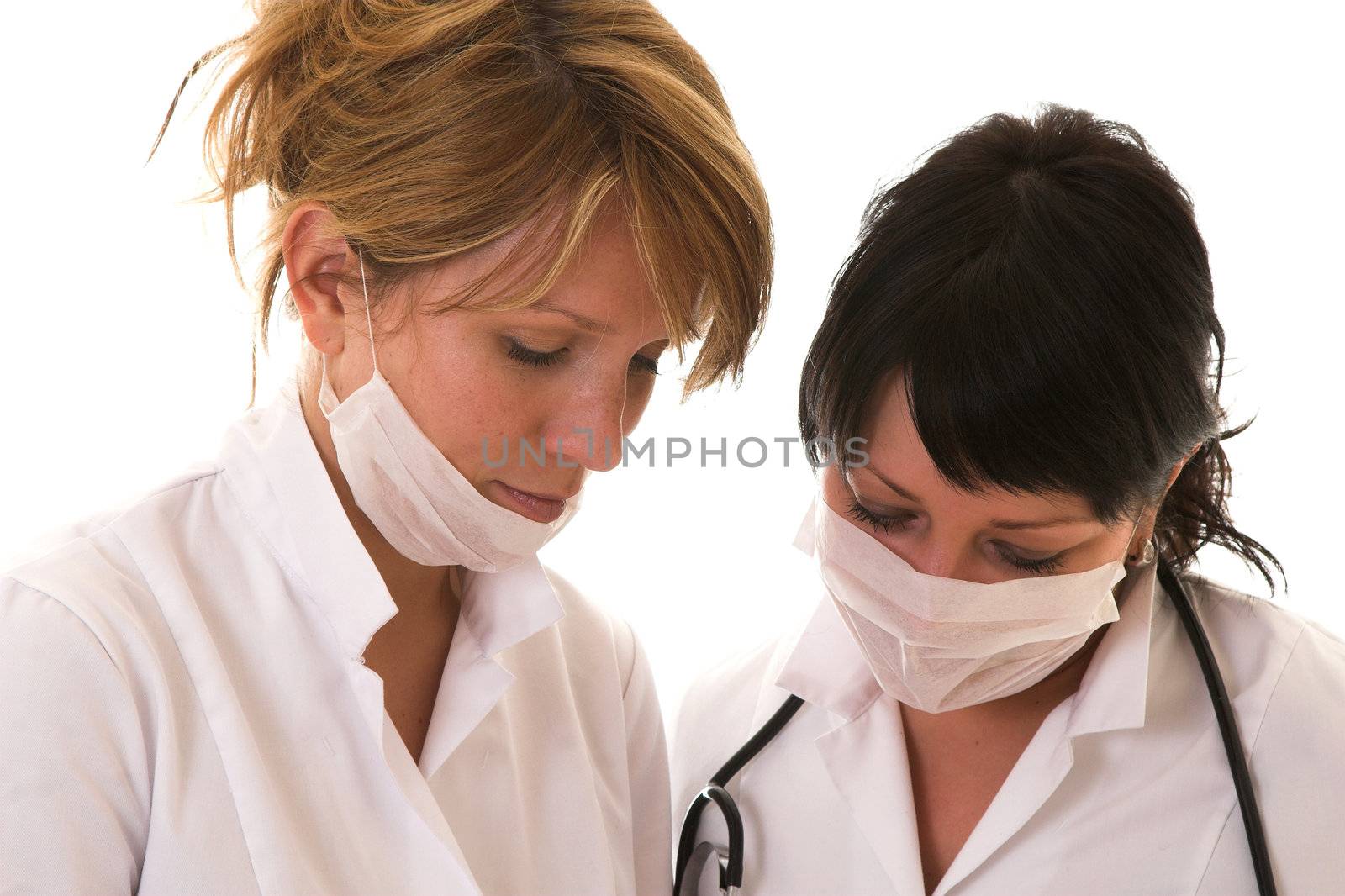 Two nurses checking their work after the operation