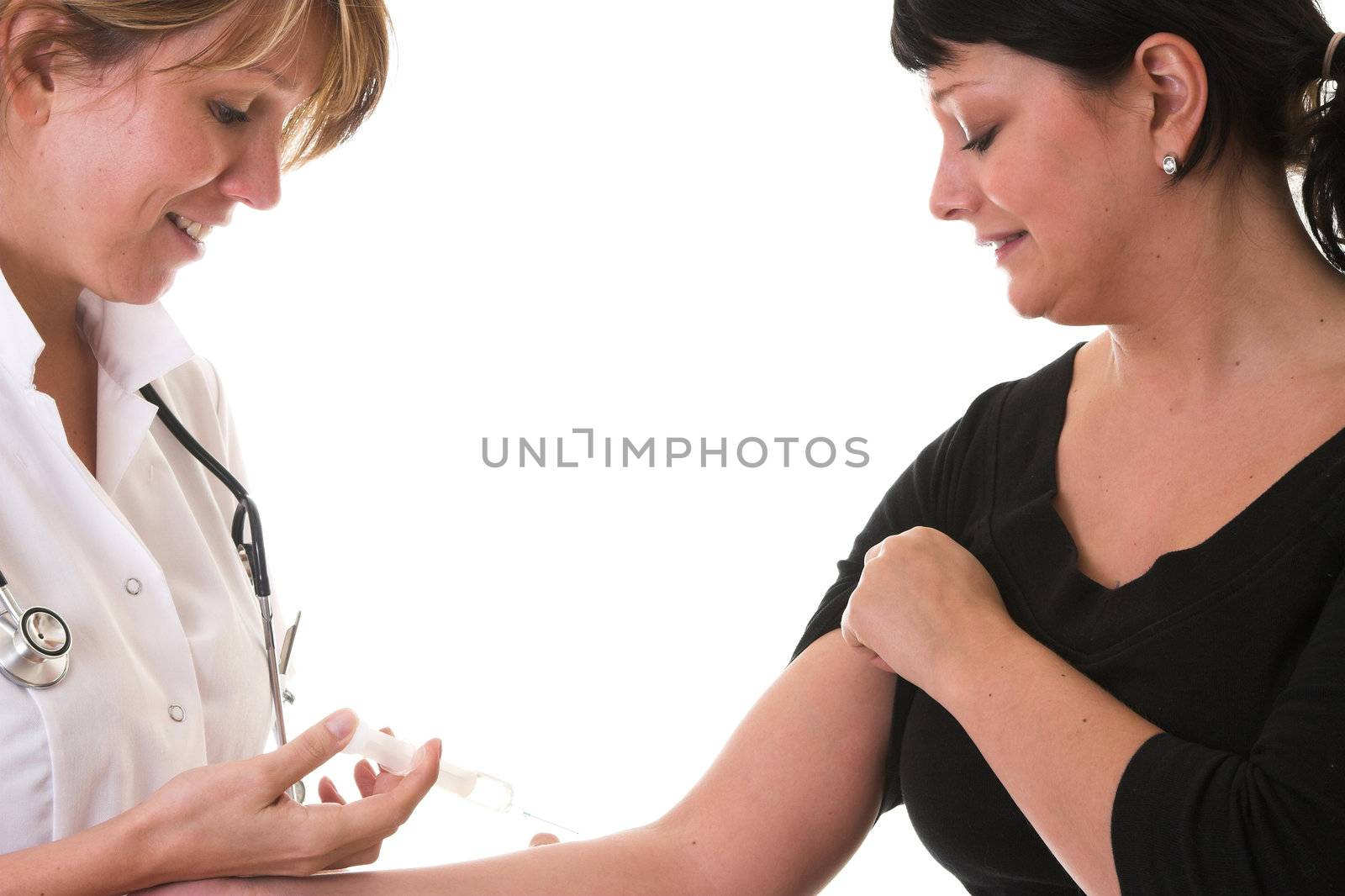 Young nurse with a syringe ready to give an injection to a scared patient
