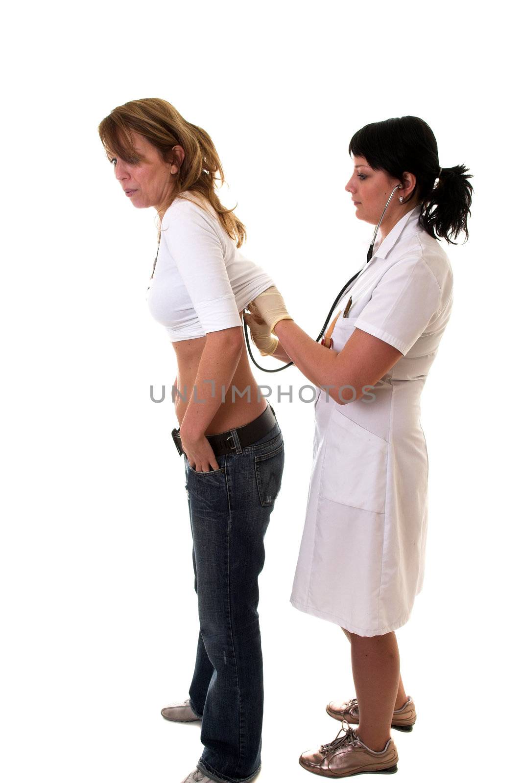 Pretty blond girl holding in her breath when she gets the stethoscope on her back