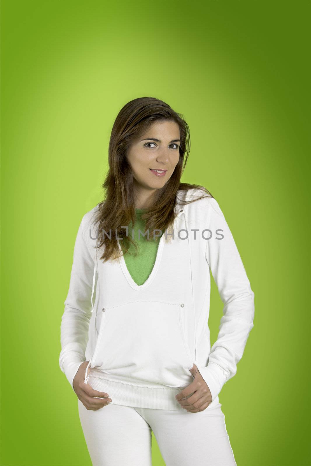 Young woman gently smiling on a green background