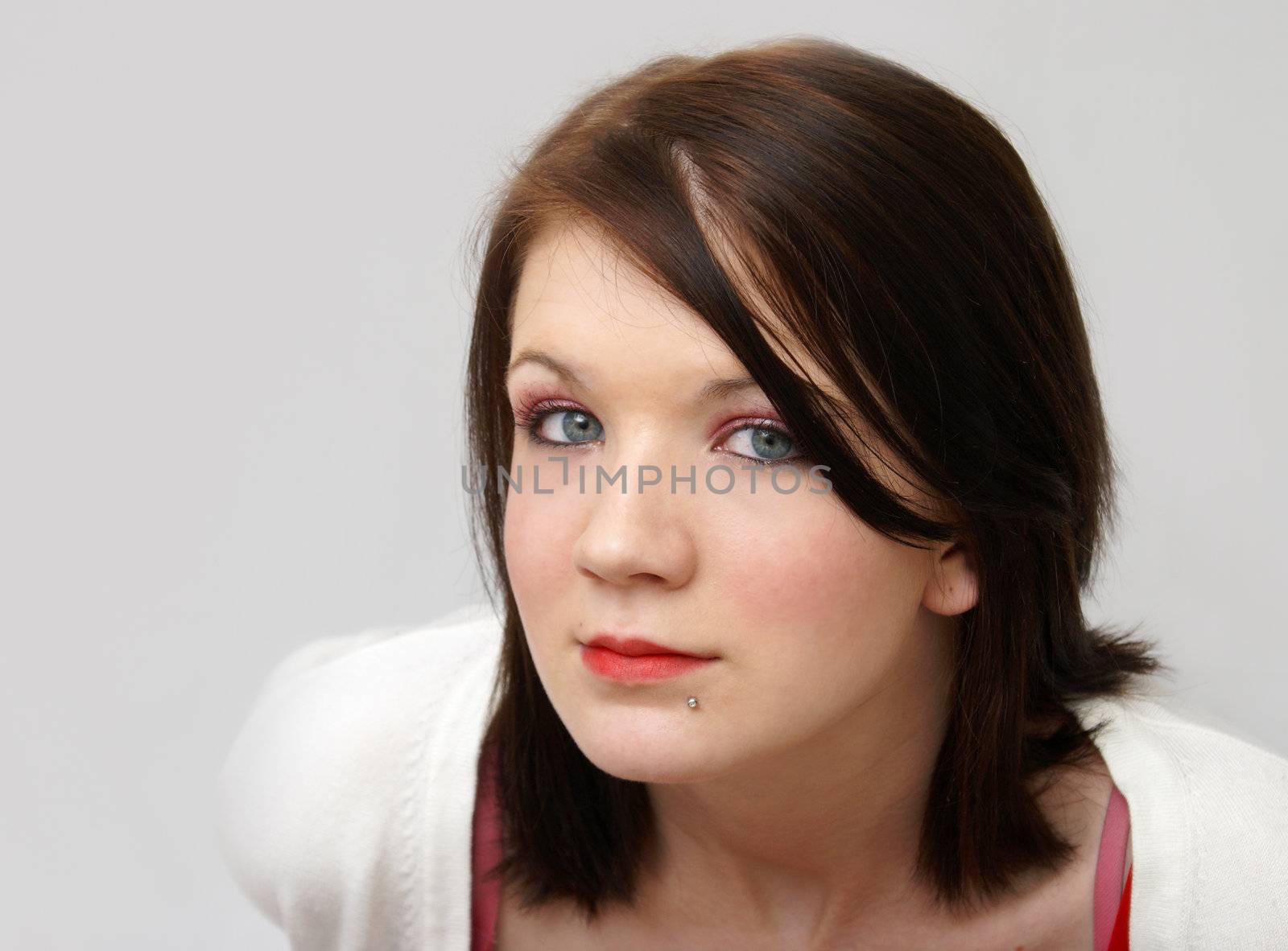 A young girl's portrait shot from above her.