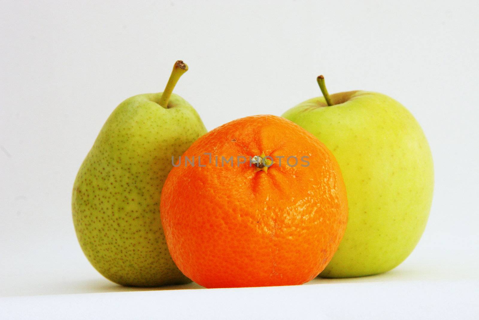 three portions of fresh fruit on a light background