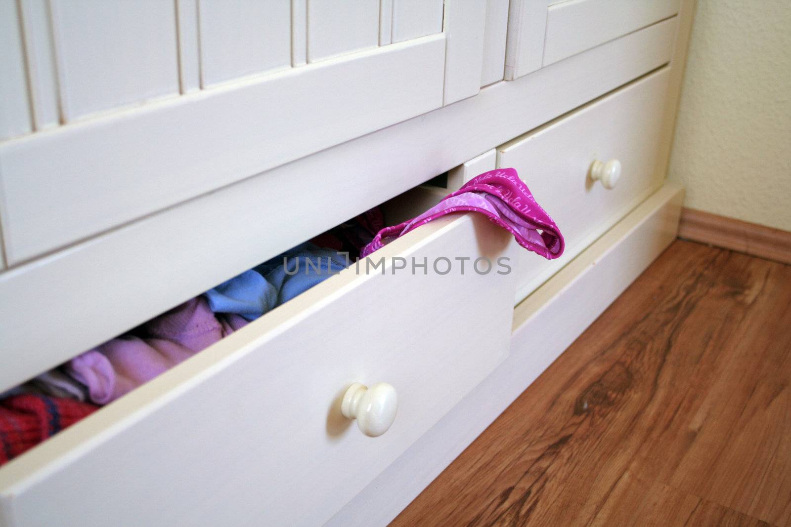 white furniture with open drawer and underpants