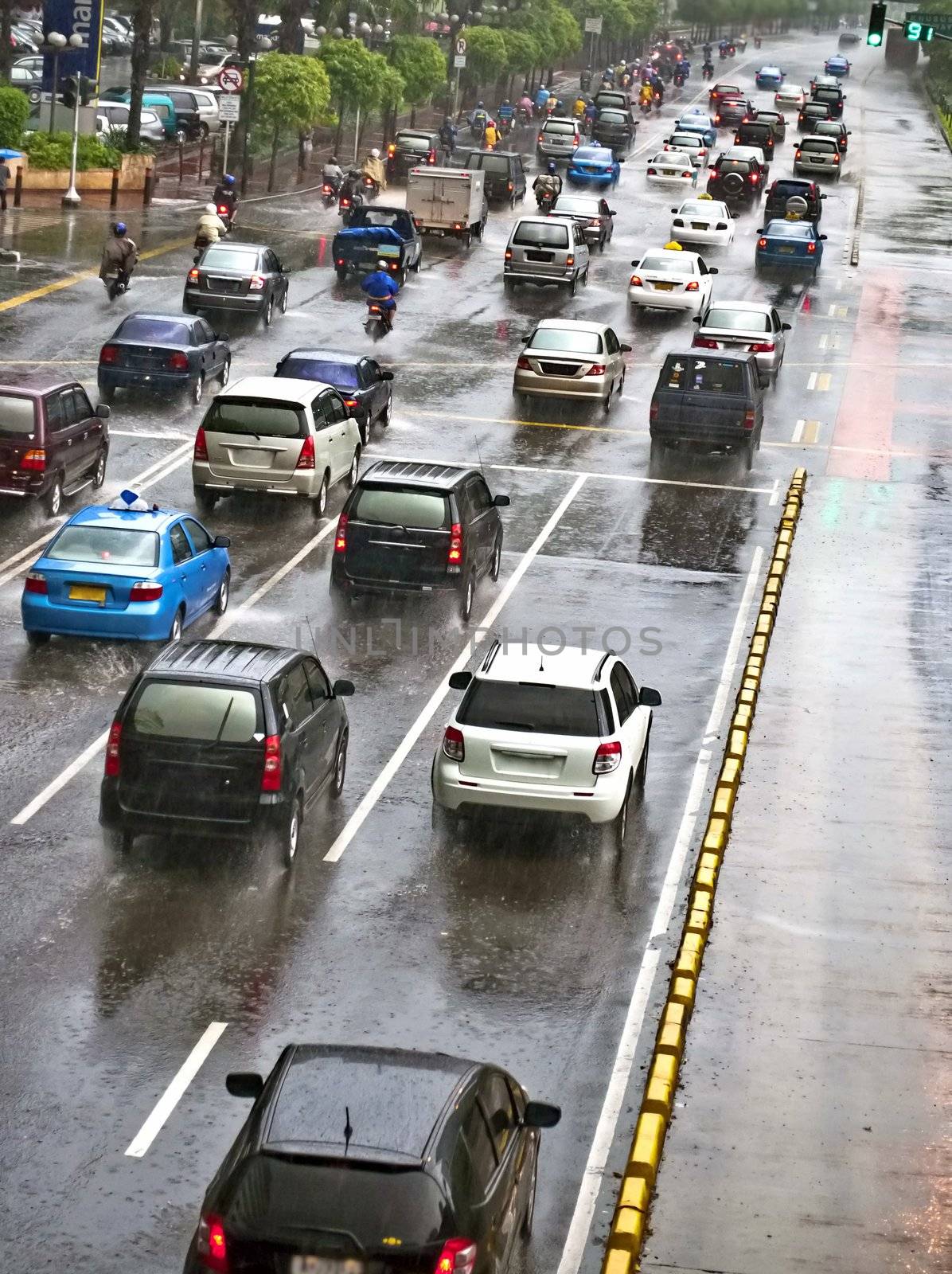 Crowded traffic jam in urban street in bad weather