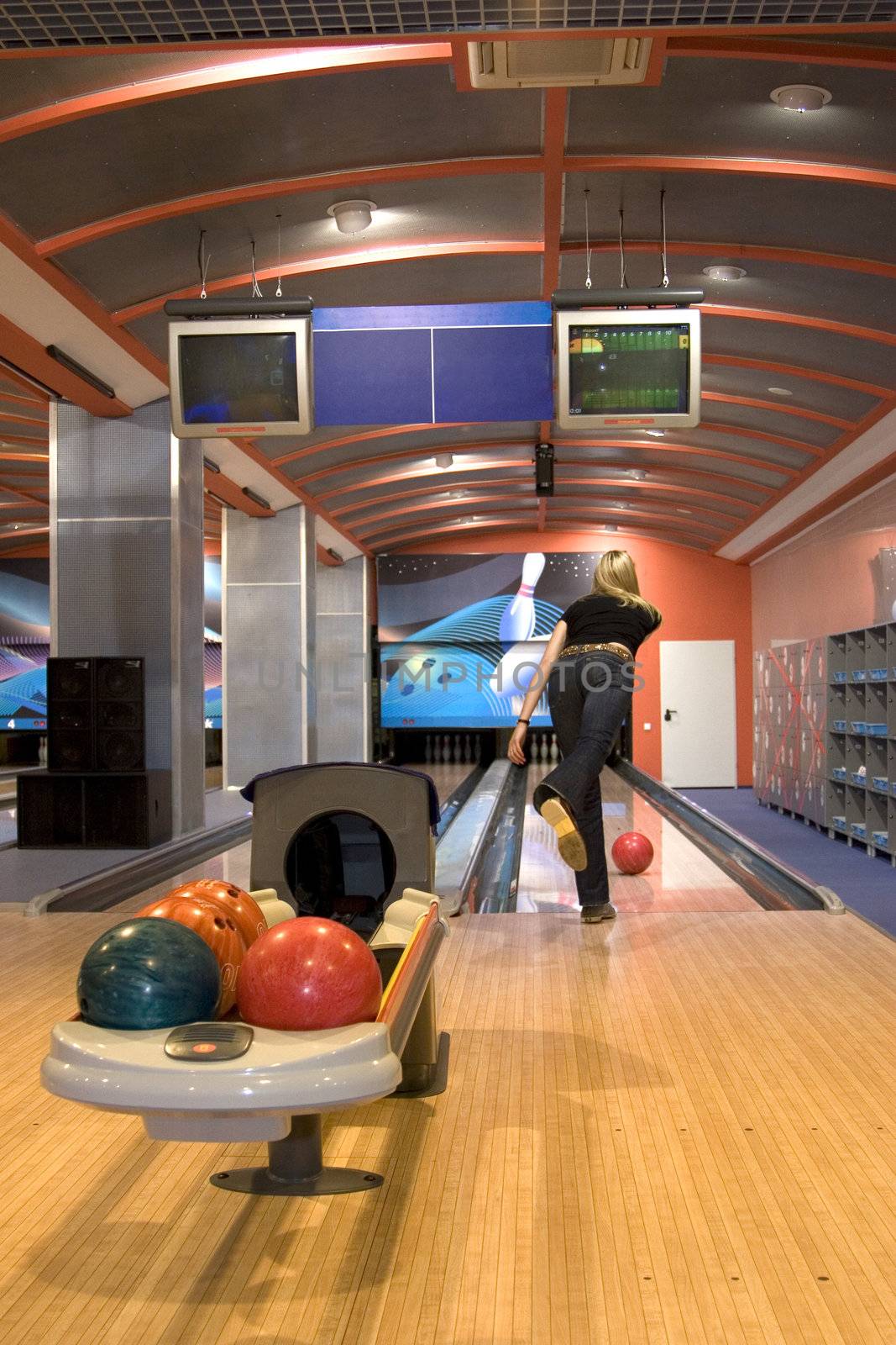 in bowling a young girl throws the ball 