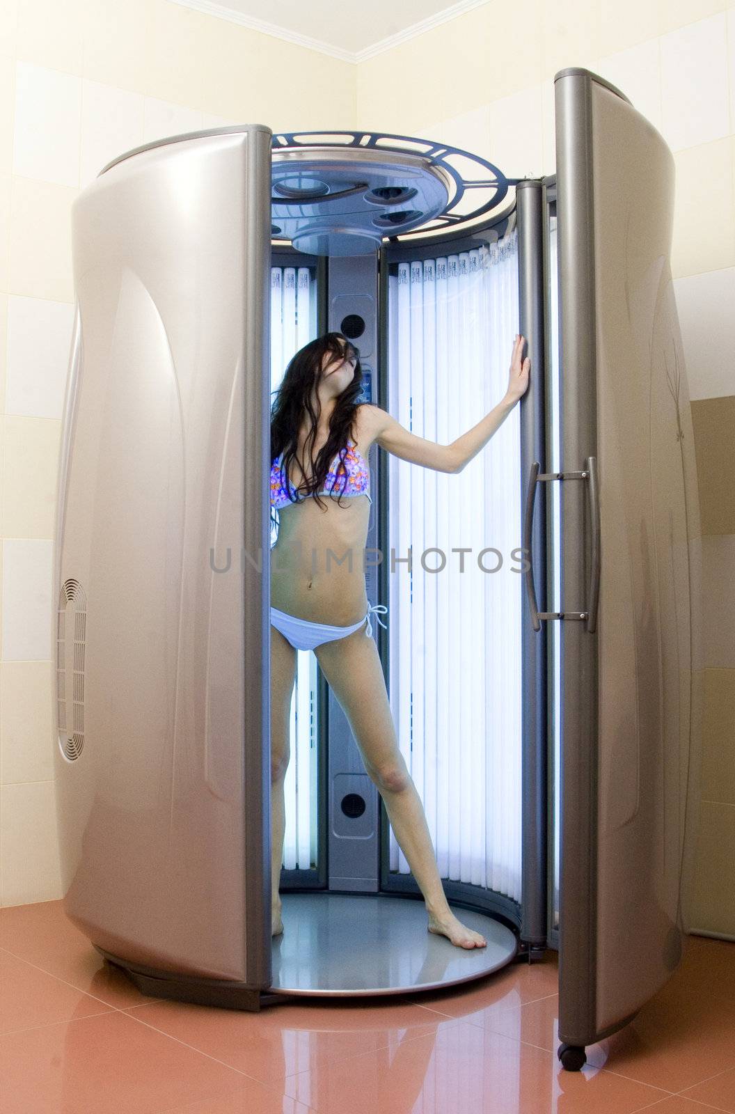 young beautiful girl in the vertical sunbeds