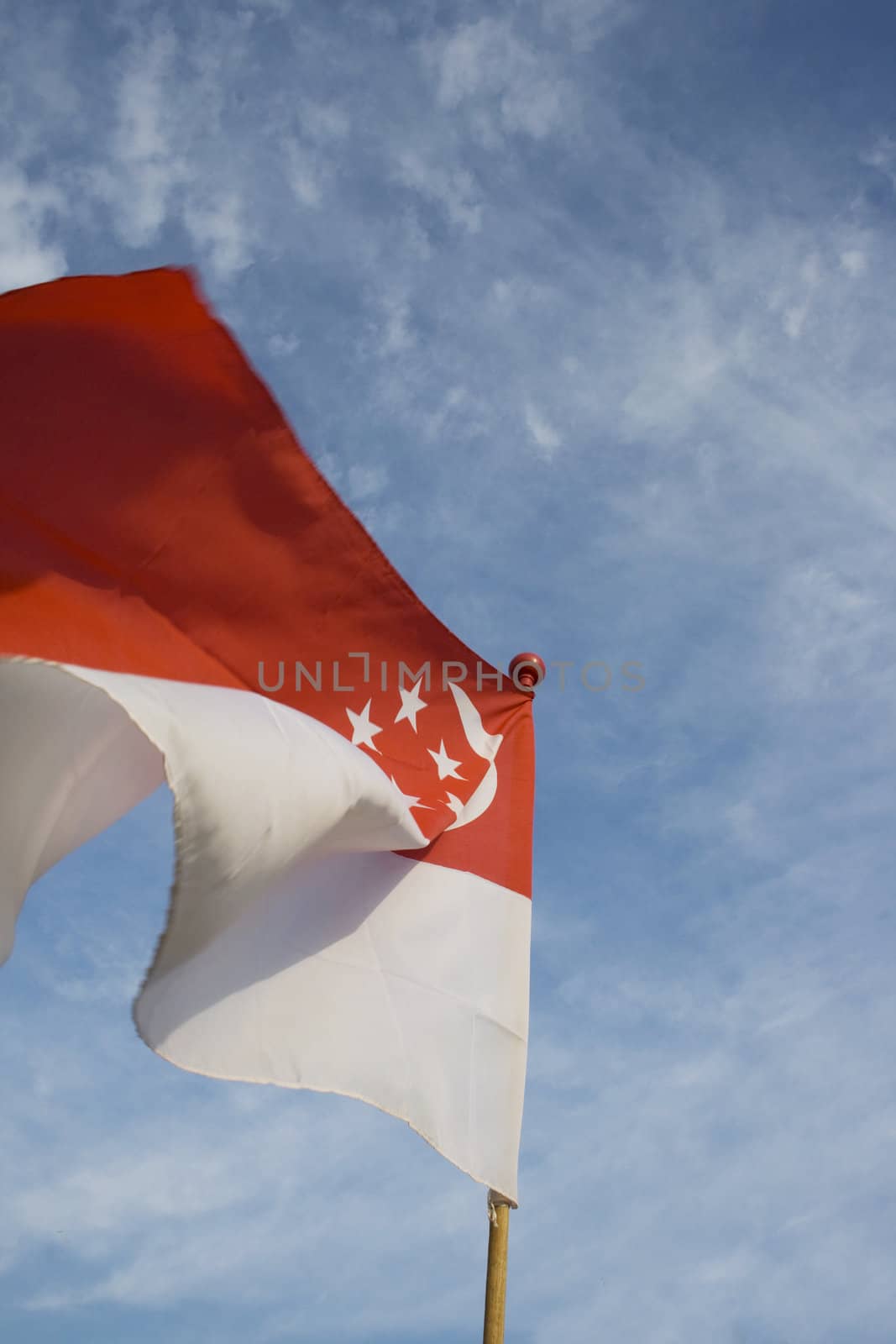 A flying Singapore flag again blue sky