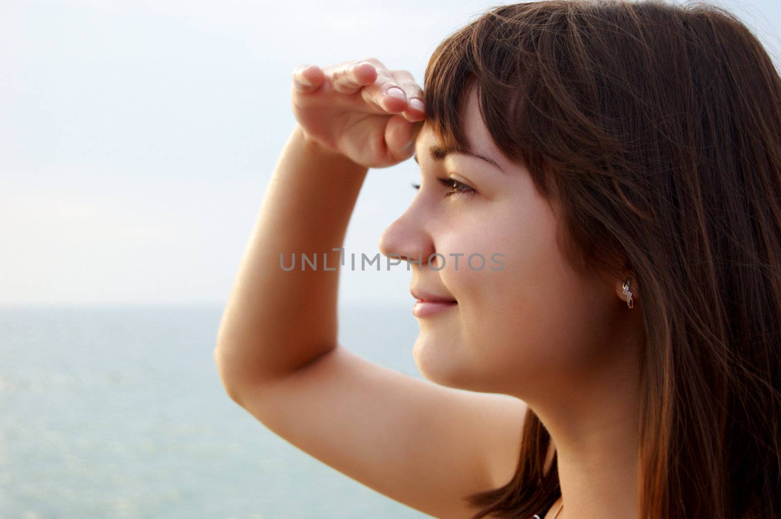 Women's sunset portrait on sea background