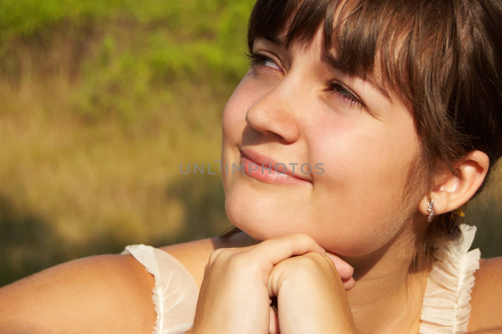 Women's sunset portrait on colored nature background