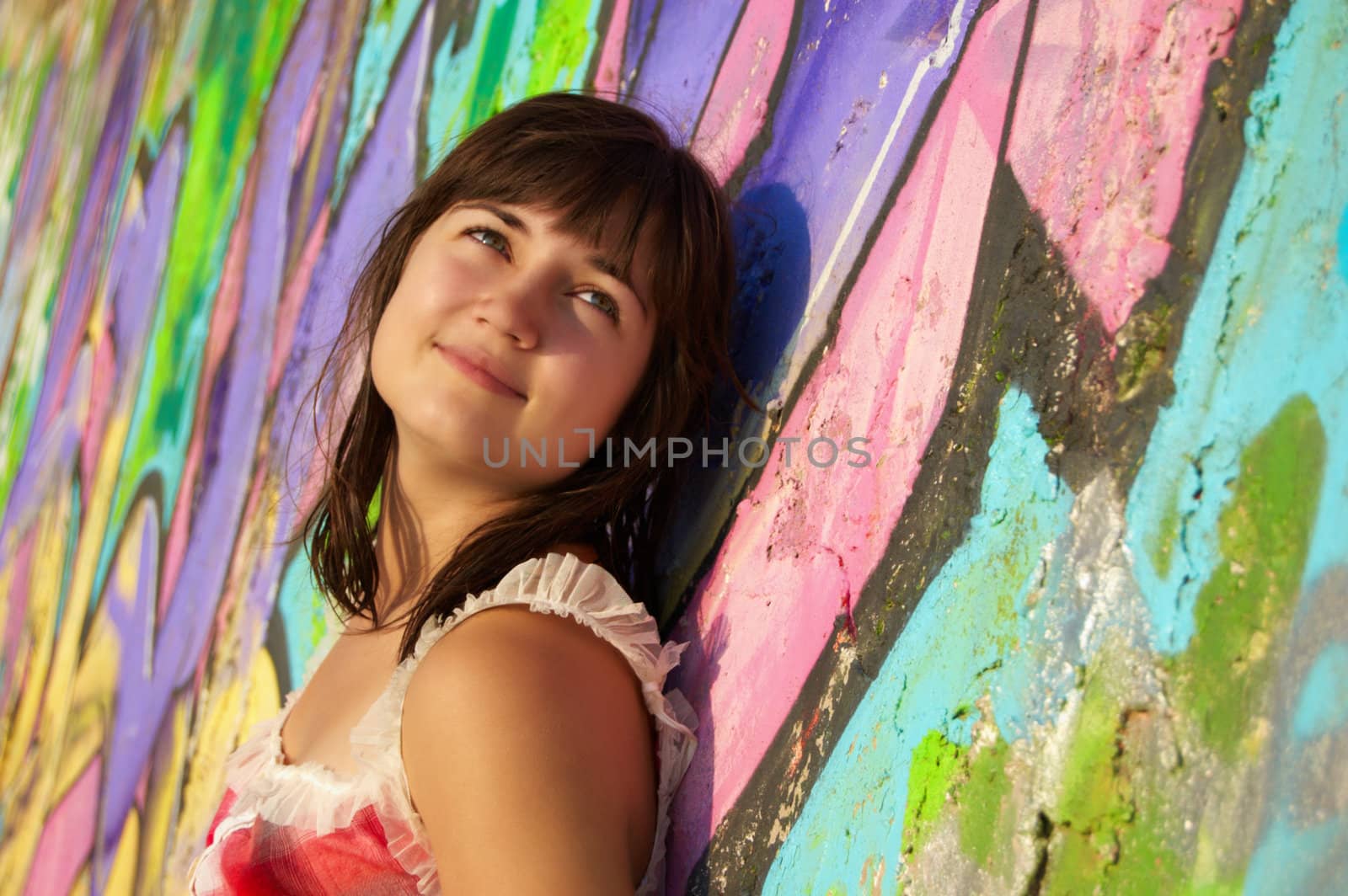 Women's  portrait on a colored wall background