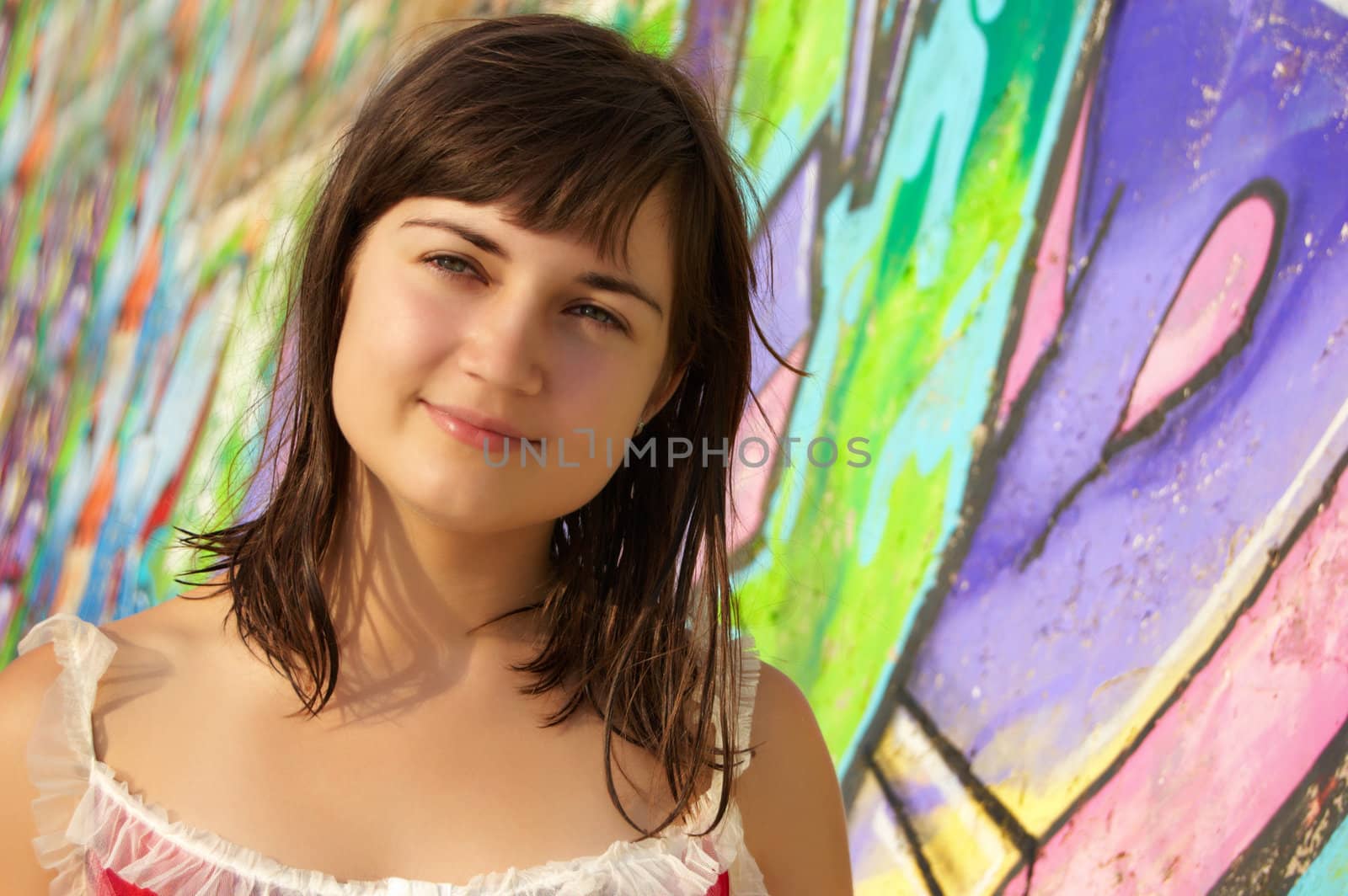 Women's  portrait on a colored wall background