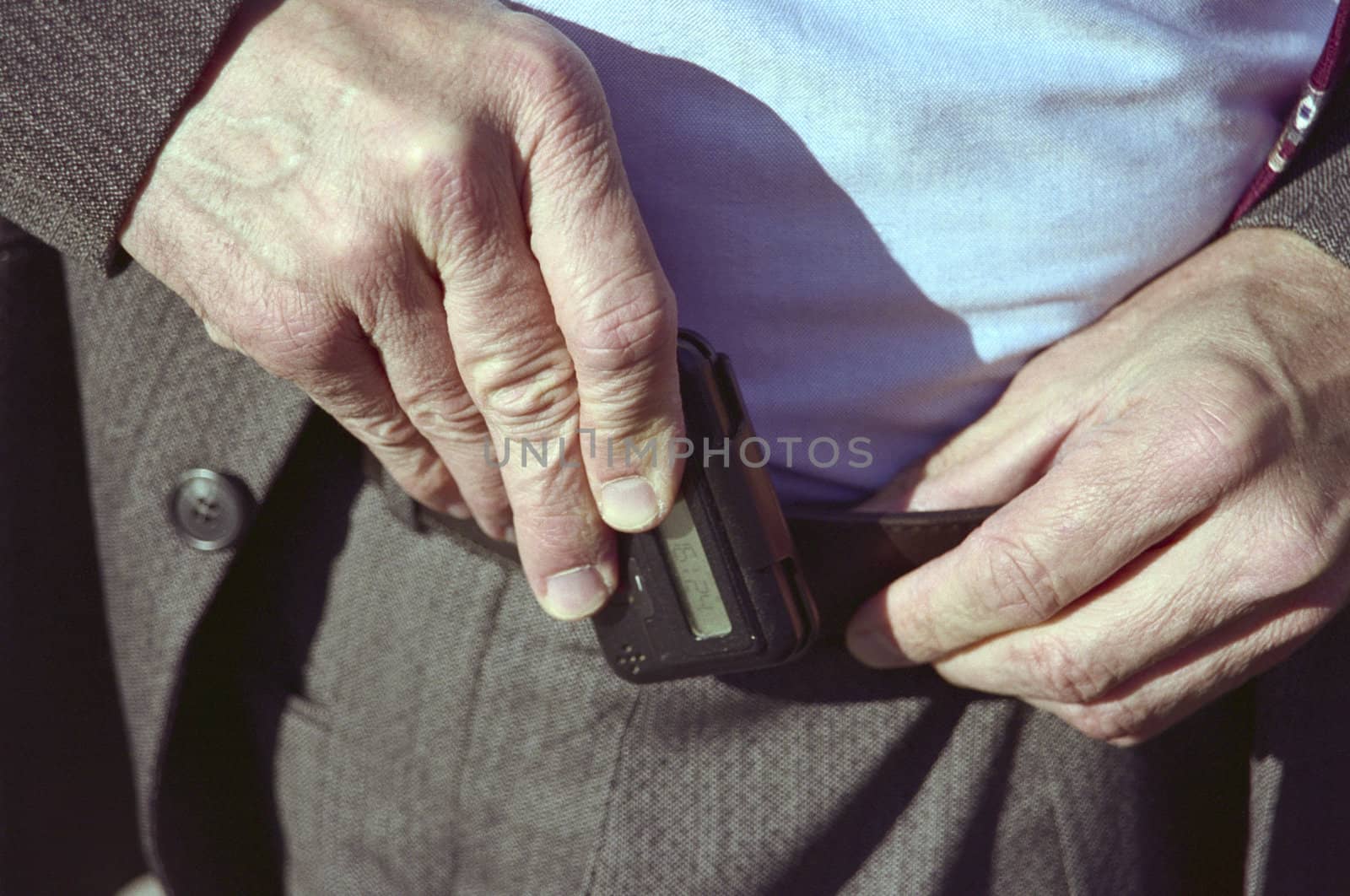 Man Clipping Pager to Trousers