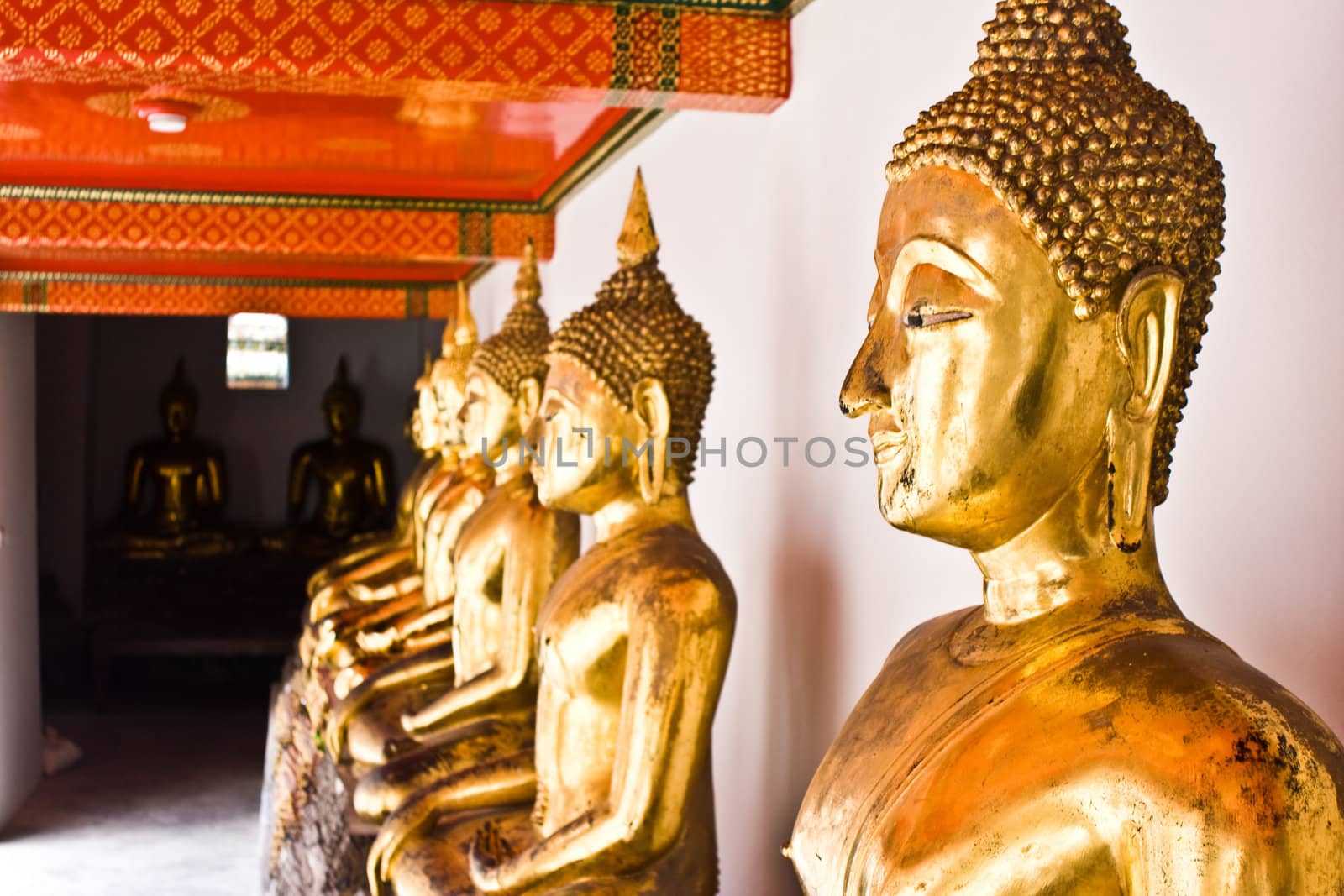 Gold Buddha statue in the Buddhist temple by pixbox77