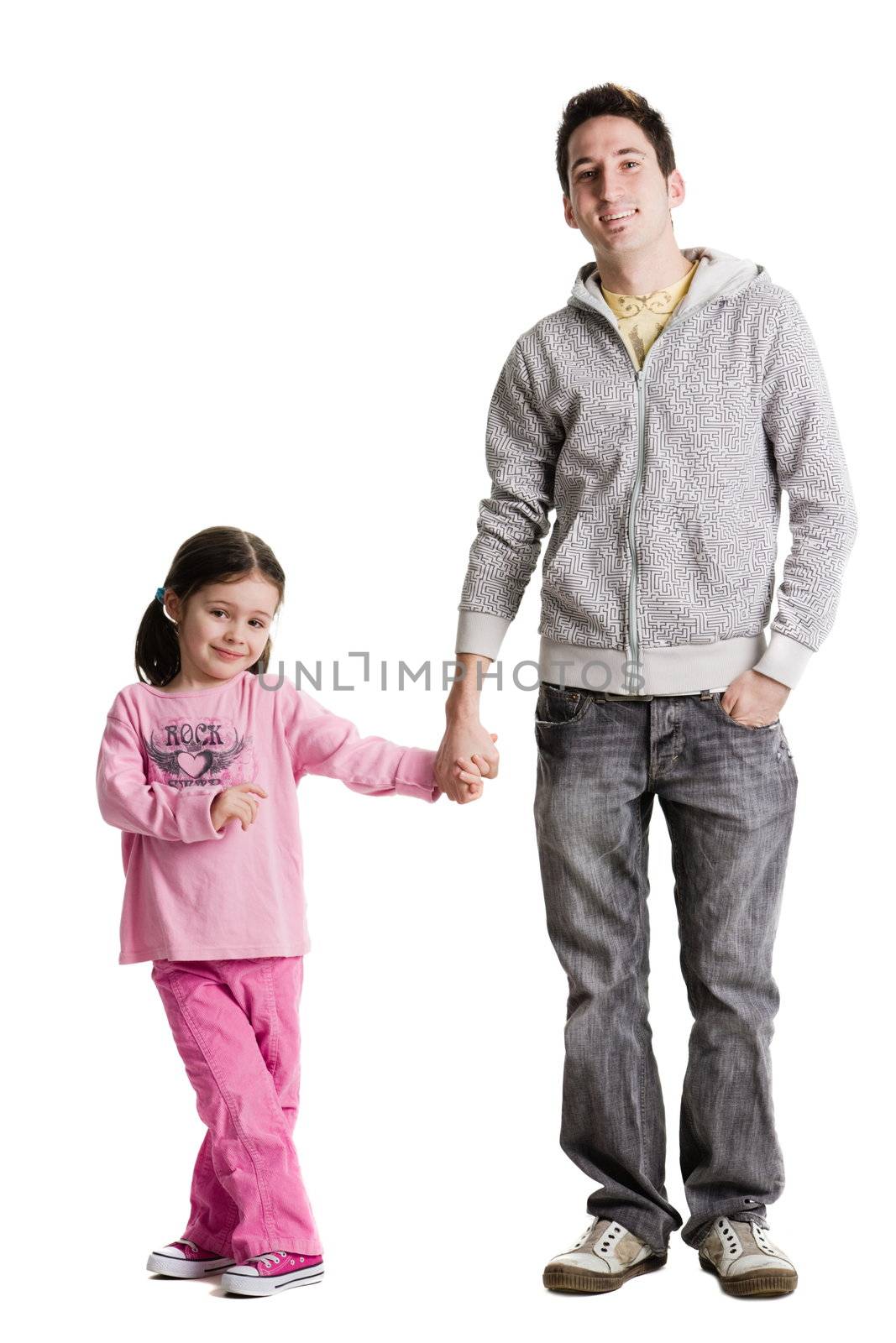 An adult holding a young girls hand on a white background