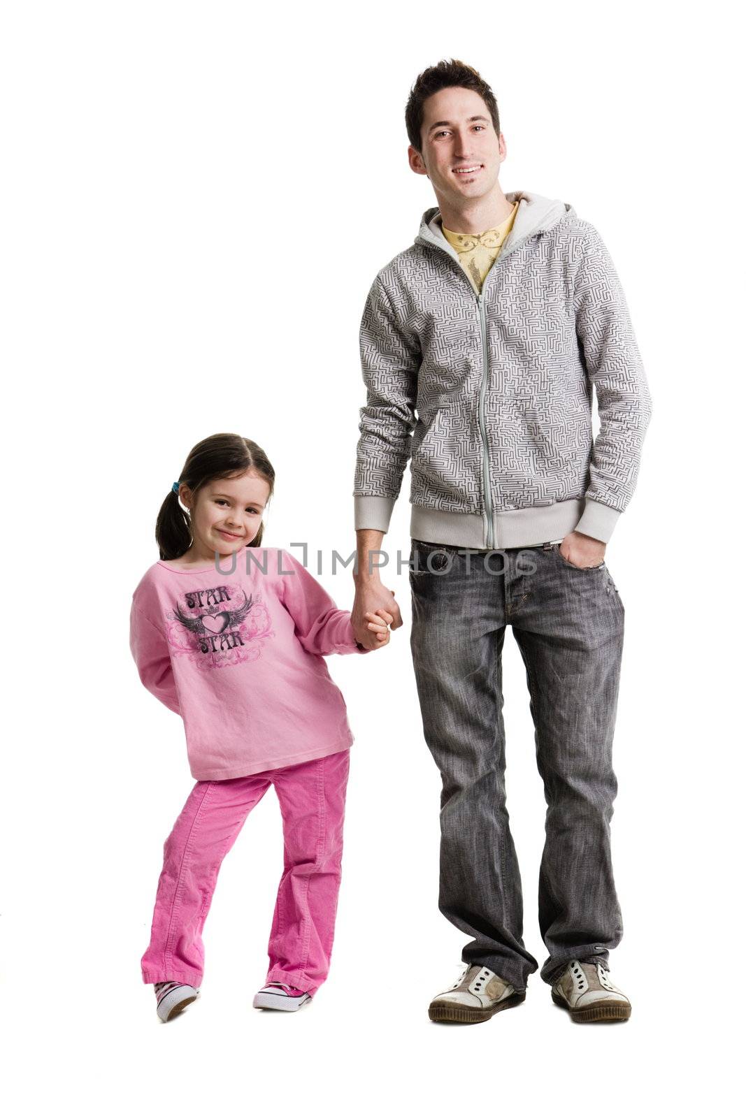 An adult holding a young girls hand on a white background